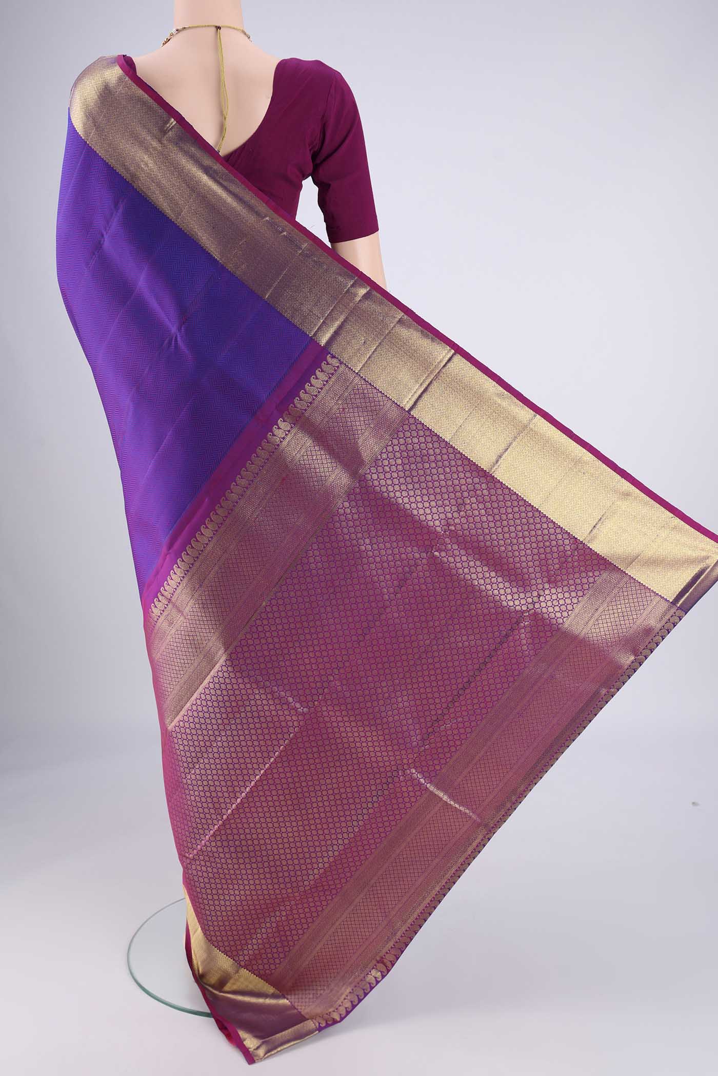Flat view of Purple Kanjivaram Silk Saree with Jacquard design on the body and Zari Border. 