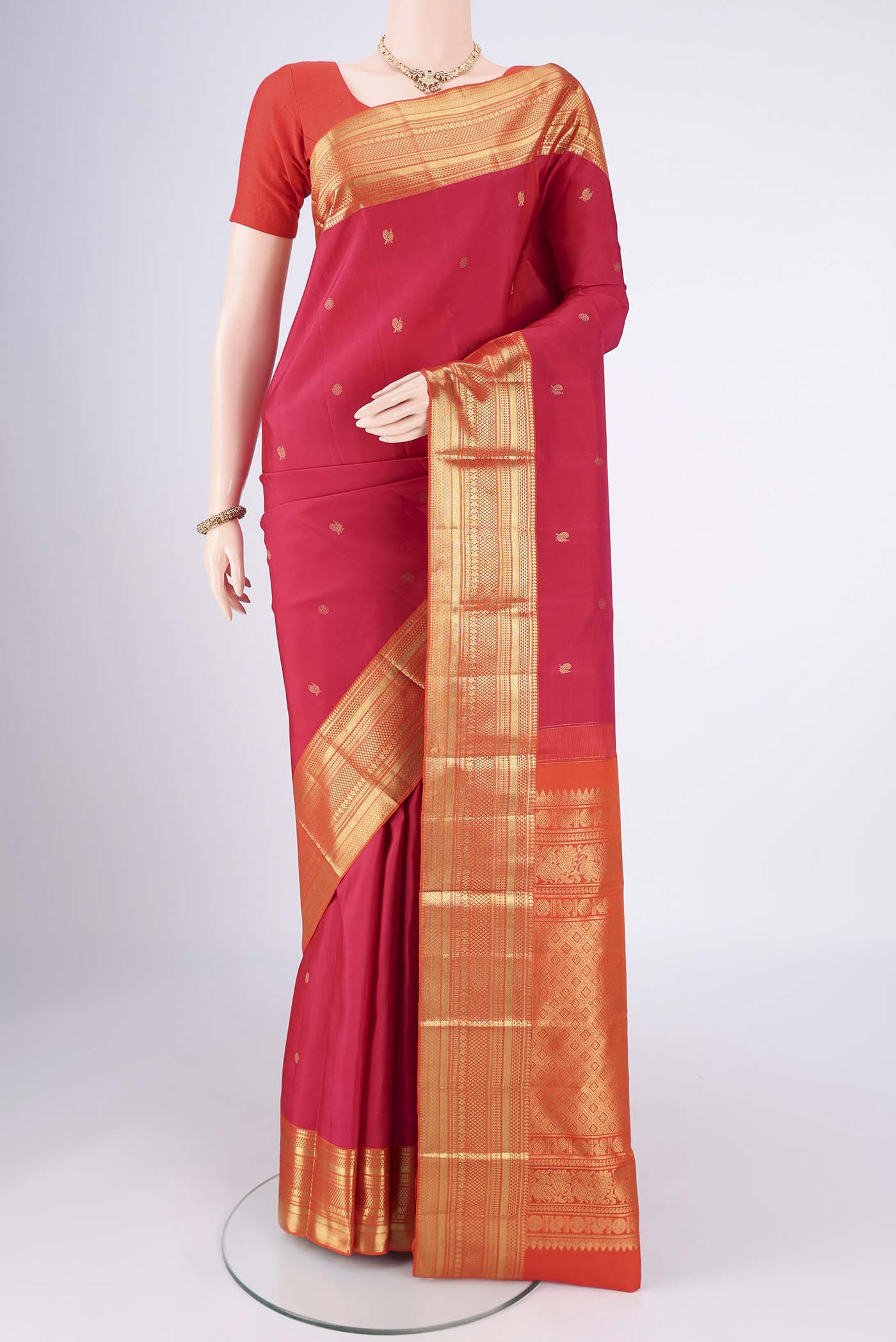 Pure Silk Pure Zari Dark Pink Kanchipuram Saree with Zari Butta on the body and Zari Border.  displayed on a mannequin
