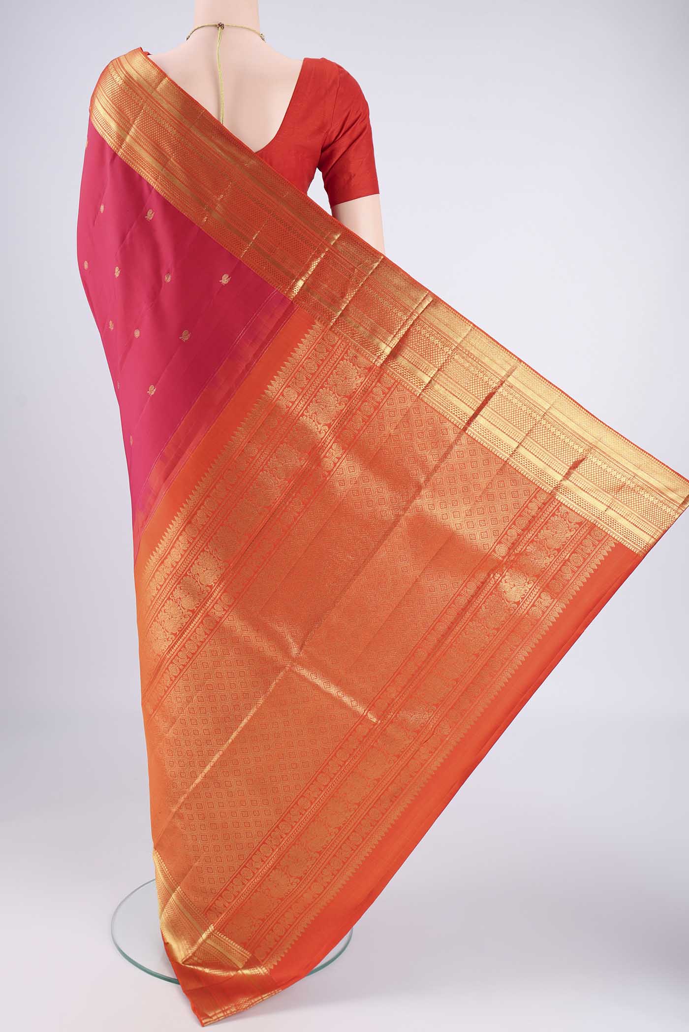 Flat view of Pure Silk Pure Zari Dark Pink Kanchipuram Saree with Zari Butta on the body and Zari Border. 