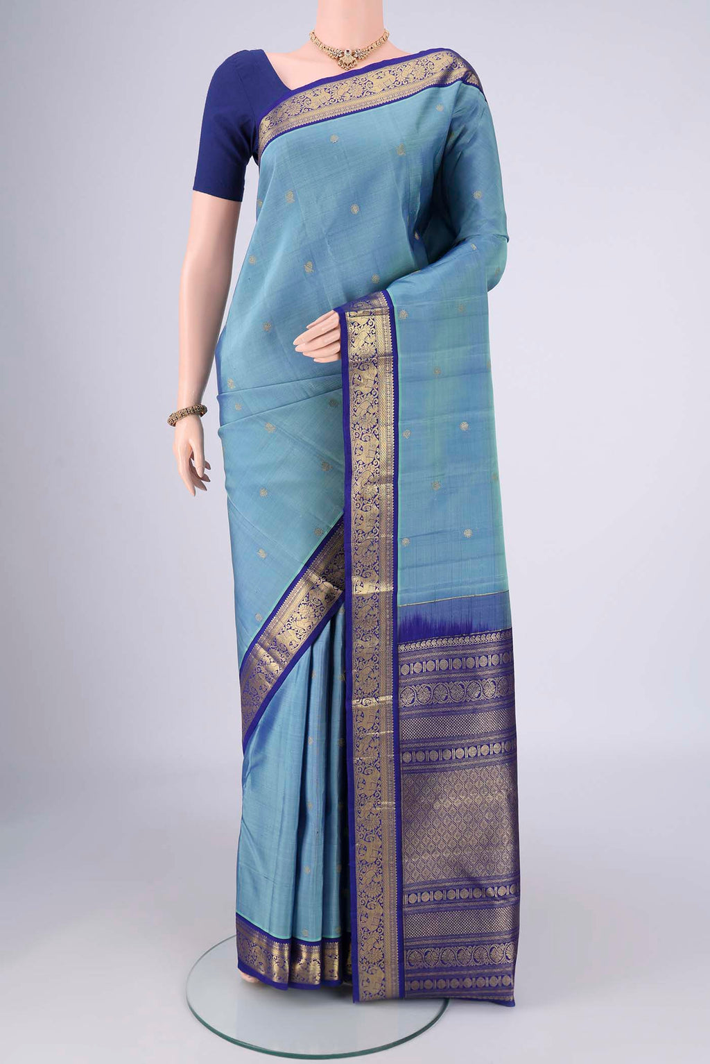 Pure Silk Pure Zari Sky Blue Kanchipuram Saree with Zari Butta on the body and Zari Border.  displayed on a mannequin