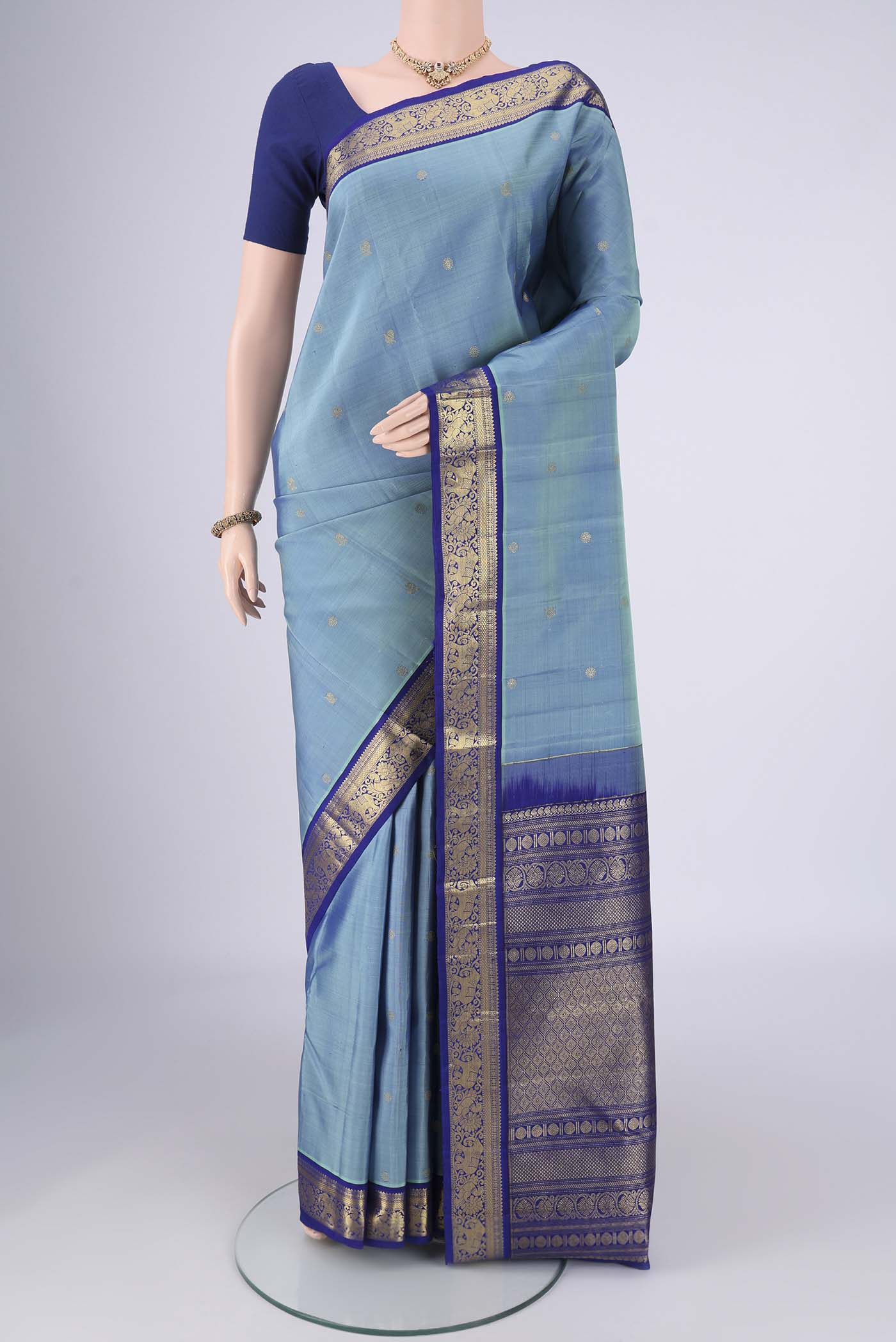 Pure Silk Pure Zari Sky Blue Kanchipuram Saree with Zari Butta on the body and Zari Border.  displayed on a mannequin