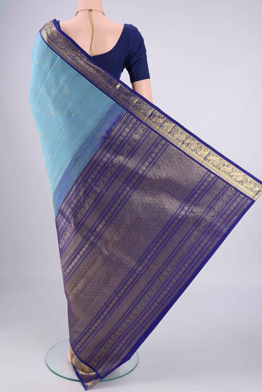 Flat view of Pure Silk Pure Zari Sky Blue Kanchipuram Saree with Zari Butta on the body and Zari Border. 