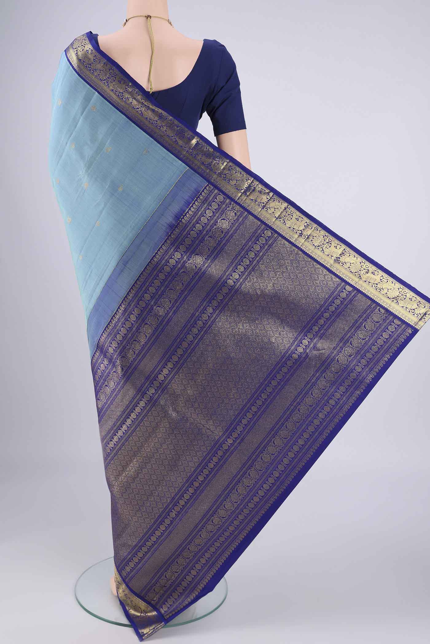 Flat view of Pure Silk Pure Zari Sky Blue Kanchipuram Saree with Zari Butta on the body and Zari Border. 