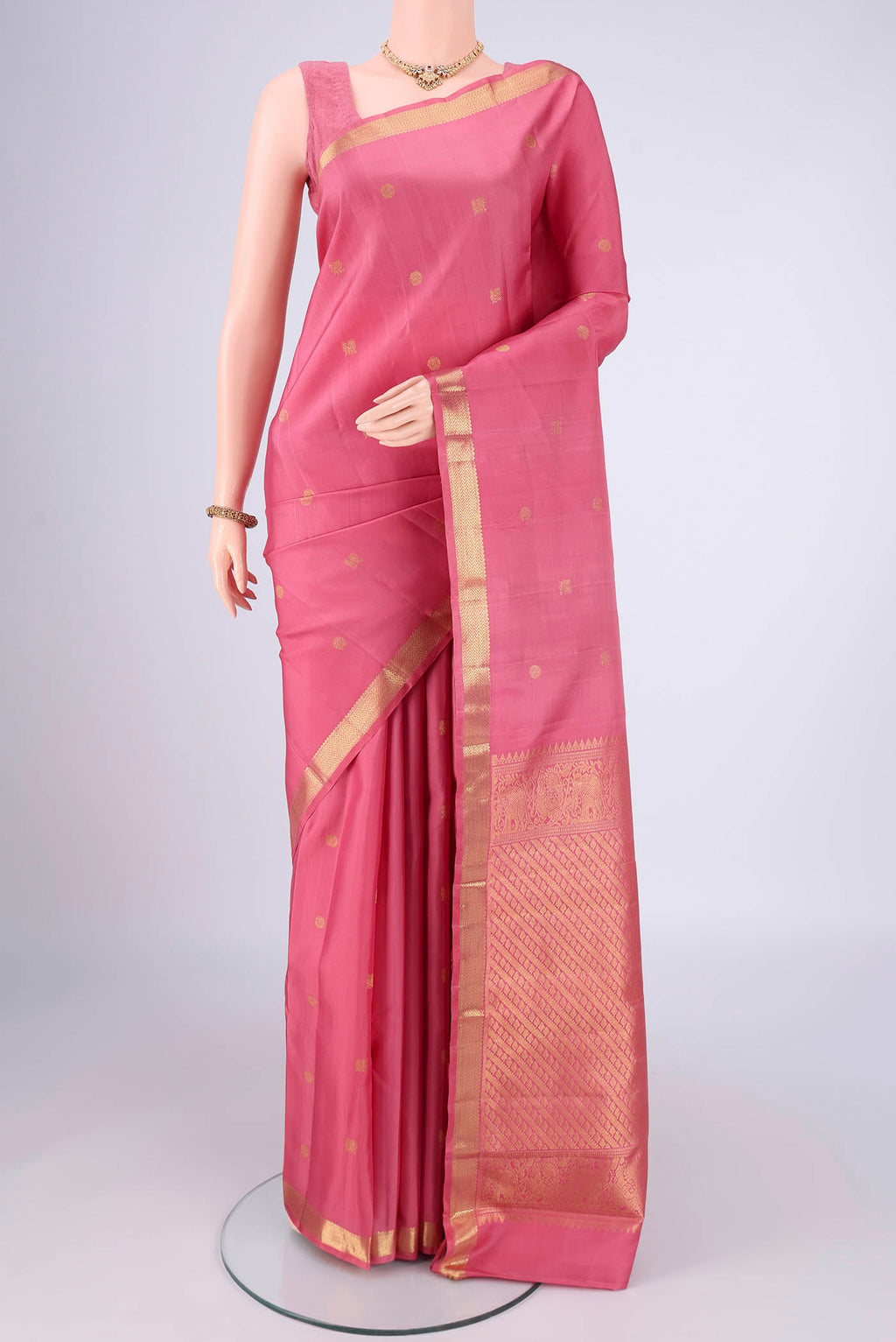 Pure Silk Pure Zari Pink Kanchipuram Saree with Zari Butta on the body and Zari Border.  displayed on a mannequin