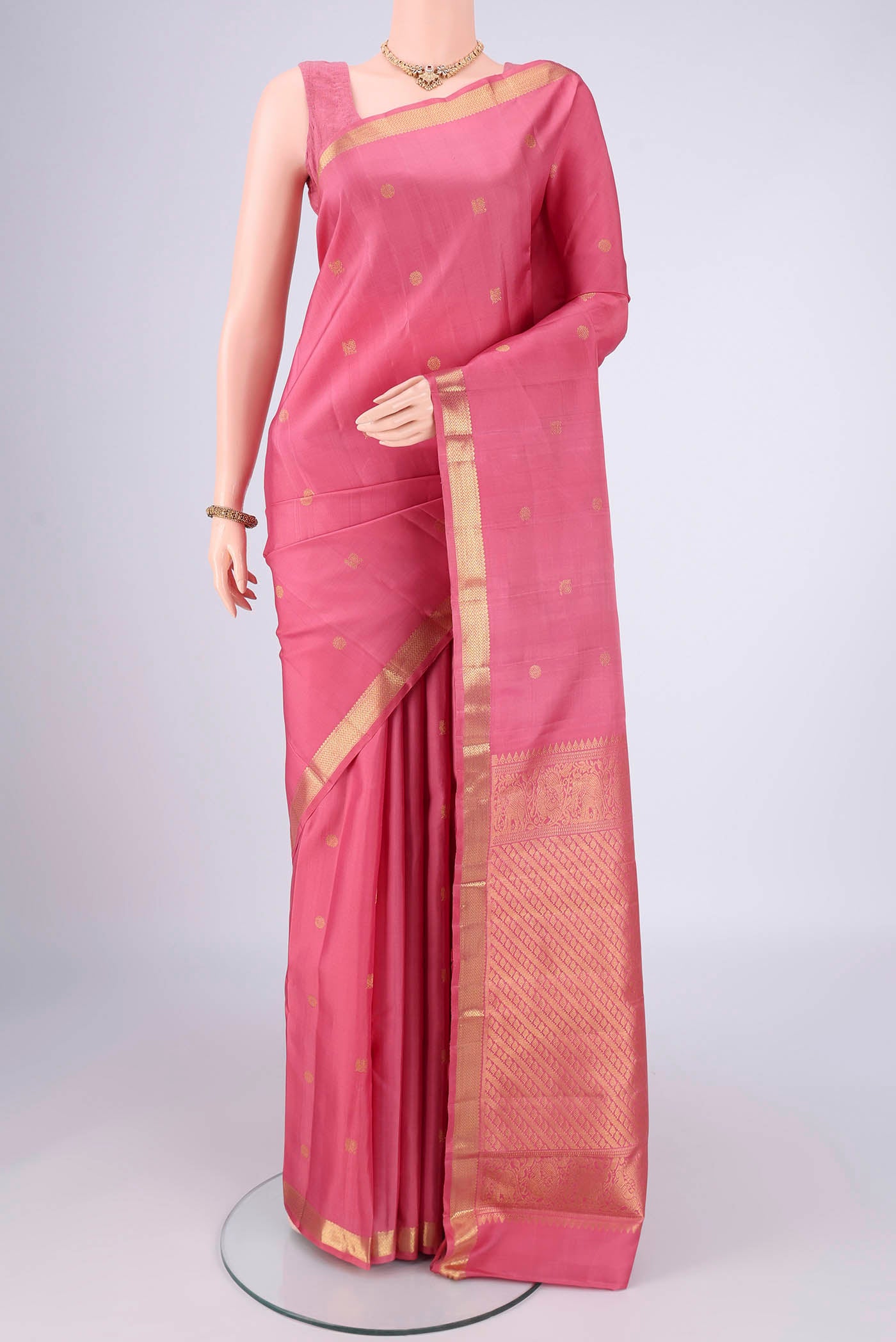 Pure Silk Pure Zari Pink Kanchipuram Saree with Zari Butta on the body and Zari Border.  displayed on a mannequin
