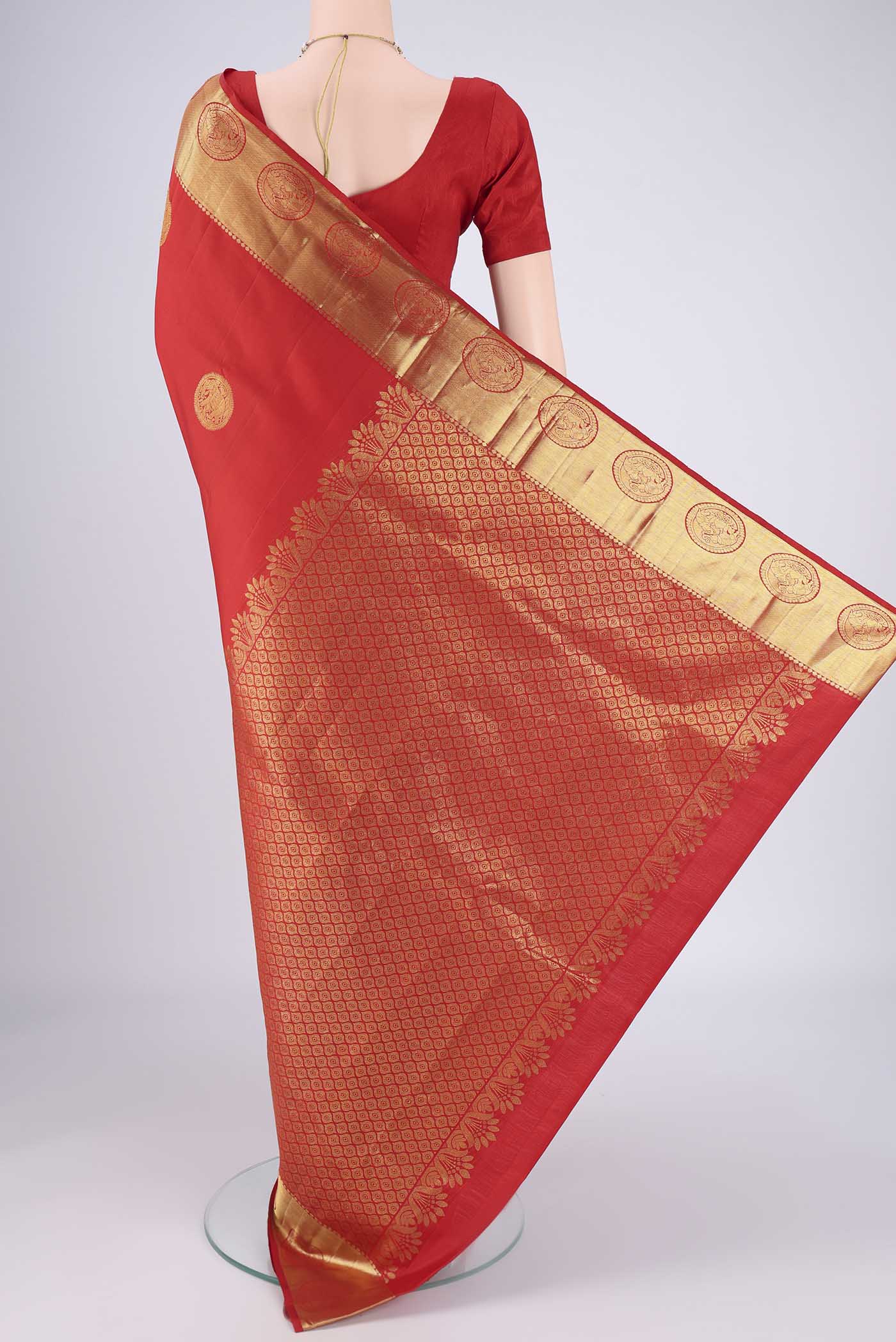 Flat view of Red Kanchipuram Silk Saree with Zari Butta on the body and Zari Border. 