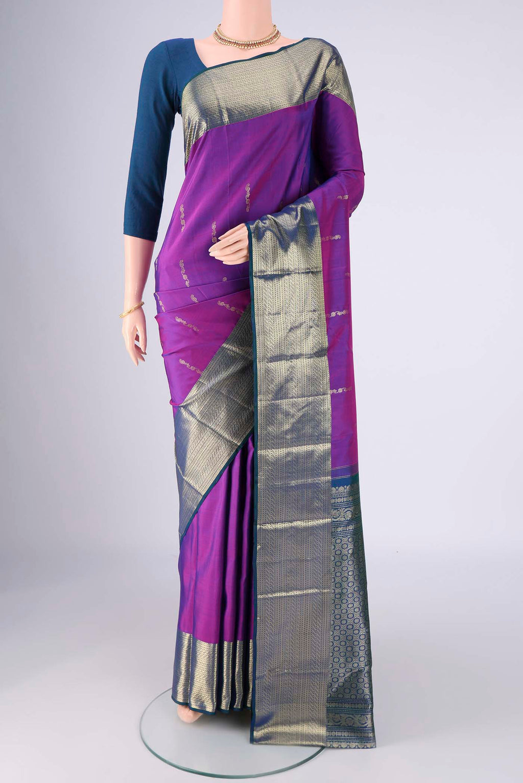 Purple Kanchipuram Saree with Zari Butta on the body and Zari Border.  displayed on a mannequin