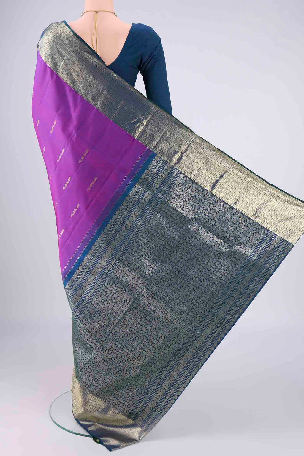 Flat view of Purple Kanchipuram Saree with Zari Butta on the body and Zari Border. 