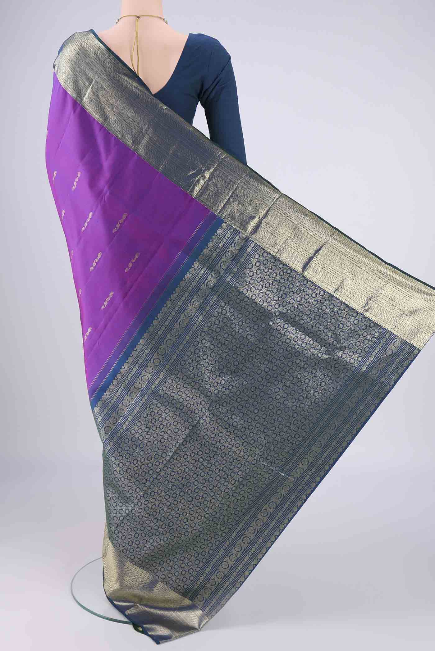 Flat view of Purple Kanchipuram Saree with Zari Butta on the body and Zari Border. 
