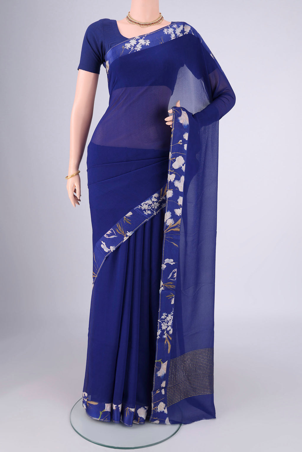 Blue Mysore Chiffon Saree with Plain Body and Printed Border.  displayed on a mannequin