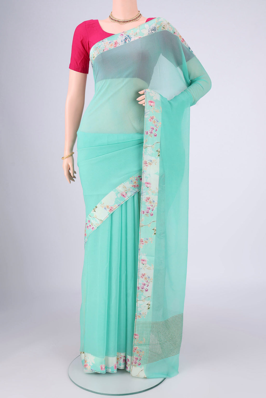 Turquoise Mysore Chiffon Saree with Plain Body and Printed Border.  displayed on a mannequin