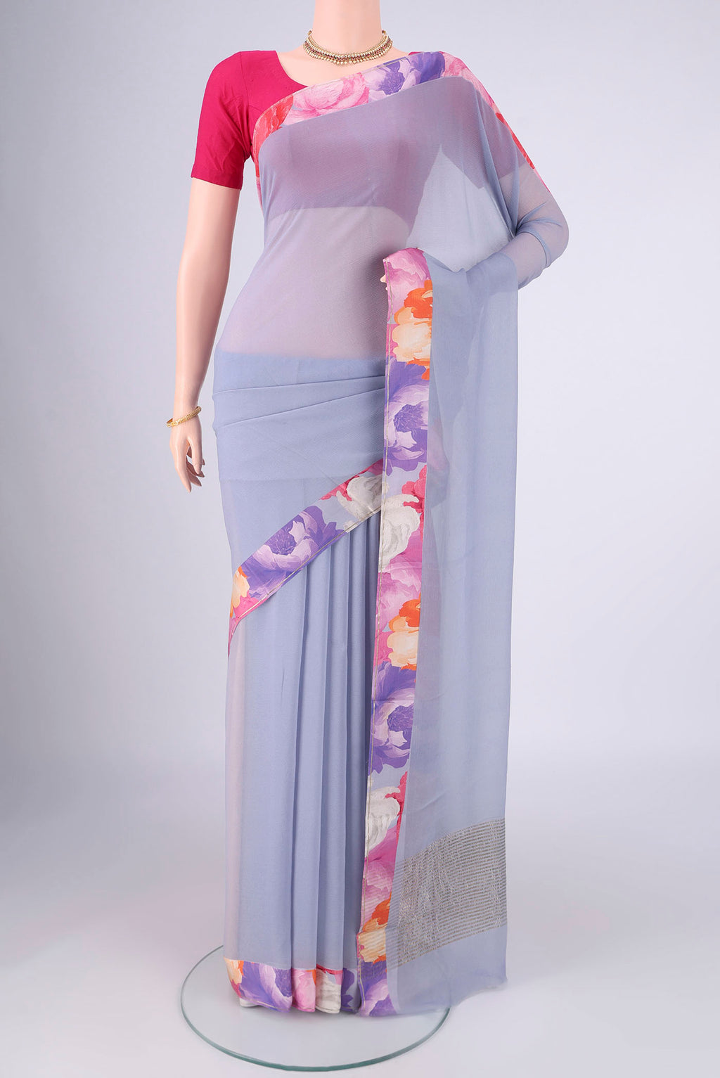 Blue Grey Mysore Chiffon Saree with Plain Body and Printed Border.  displayed on a mannequin