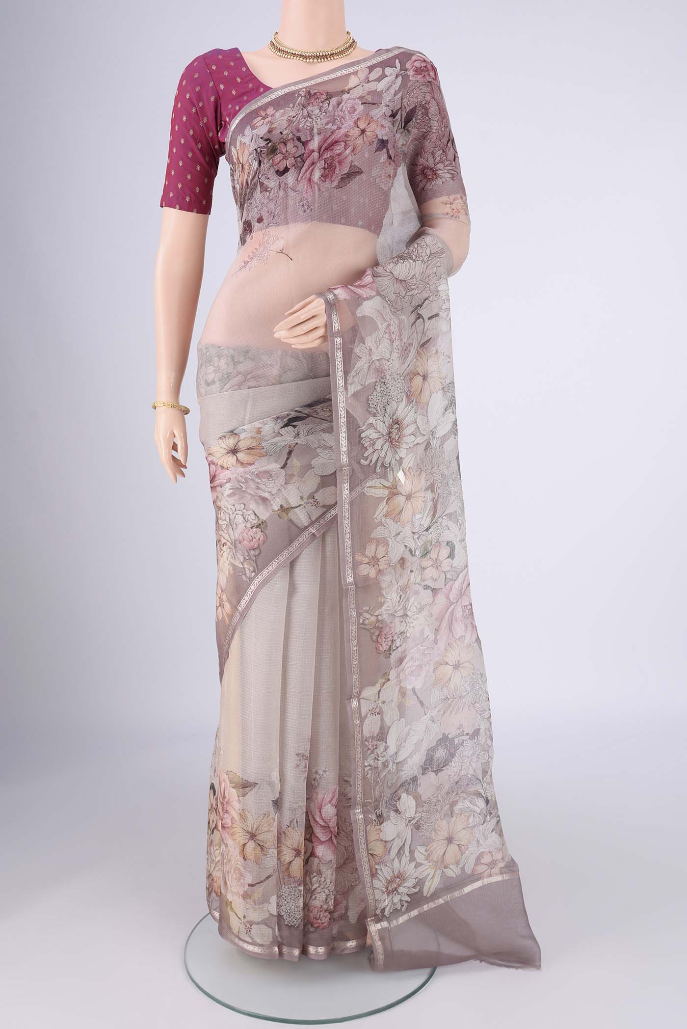 Grey Kota Silk Saree with Floral Print on the body and Zari Border.  displayed on a mannequin