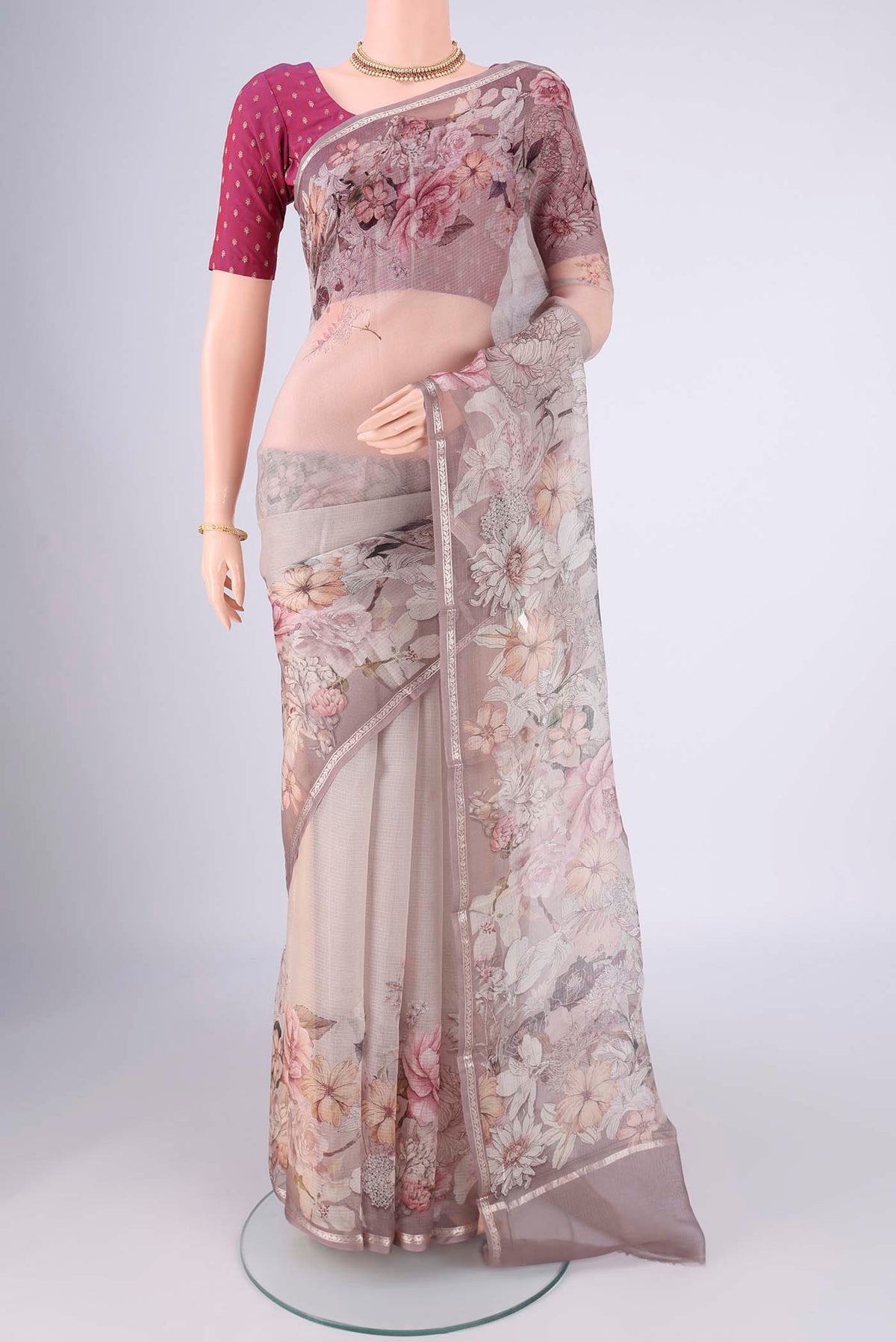 Grey Kota Silk Saree with Floral Print on the body and Zari Border.  displayed on a mannequin