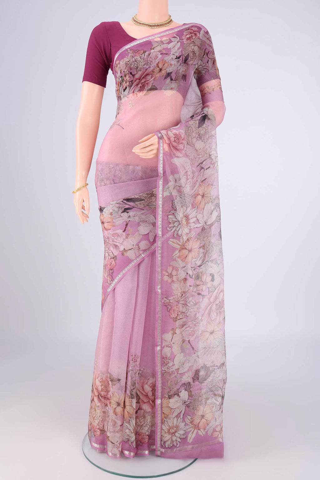 Lilac Kota Silk Saree with Floral Print on the body and Zari Border.  displayed on a mannequin