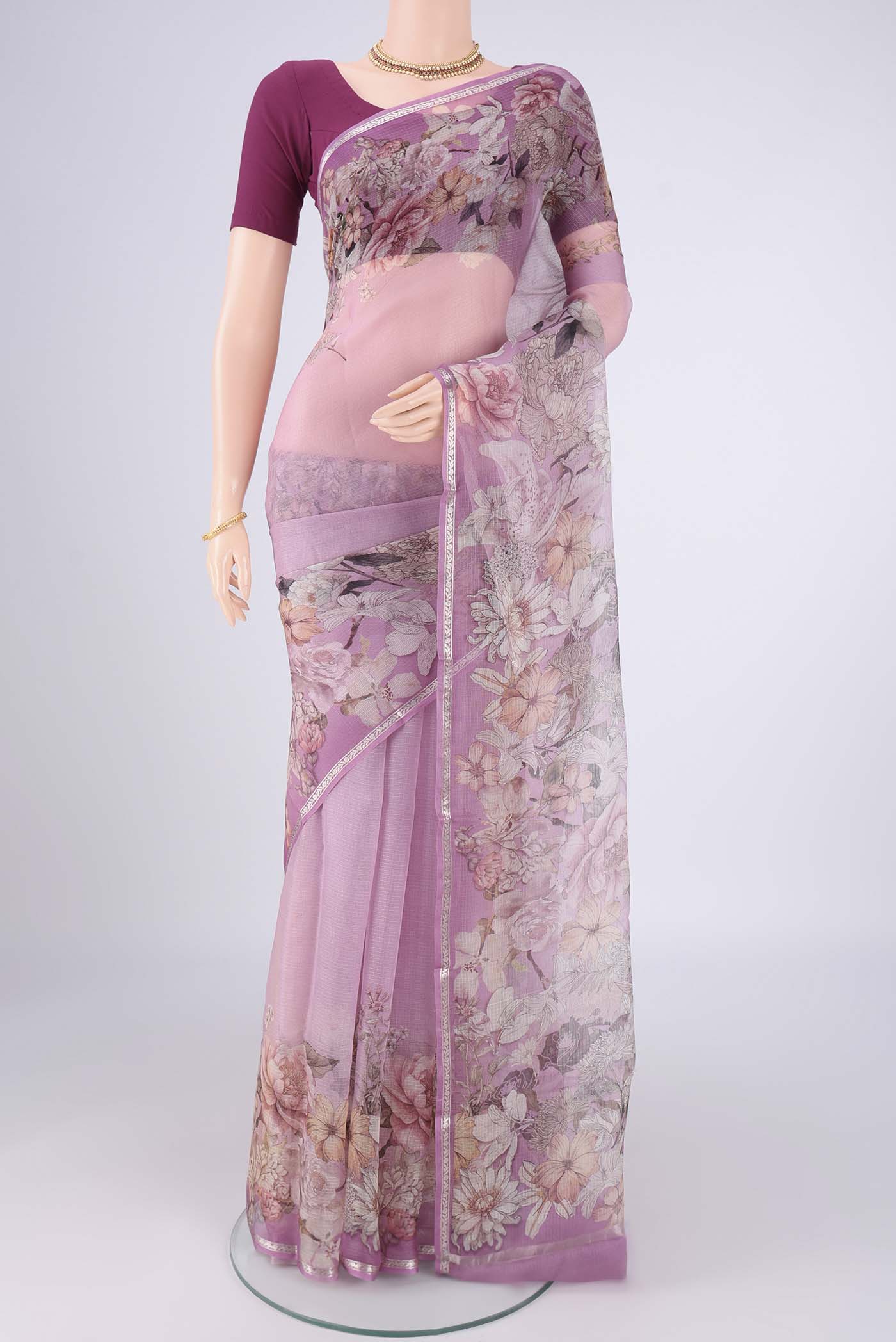 Lilac Kota Silk Saree with Floral Print on the body and Zari Border.  displayed on a mannequin
