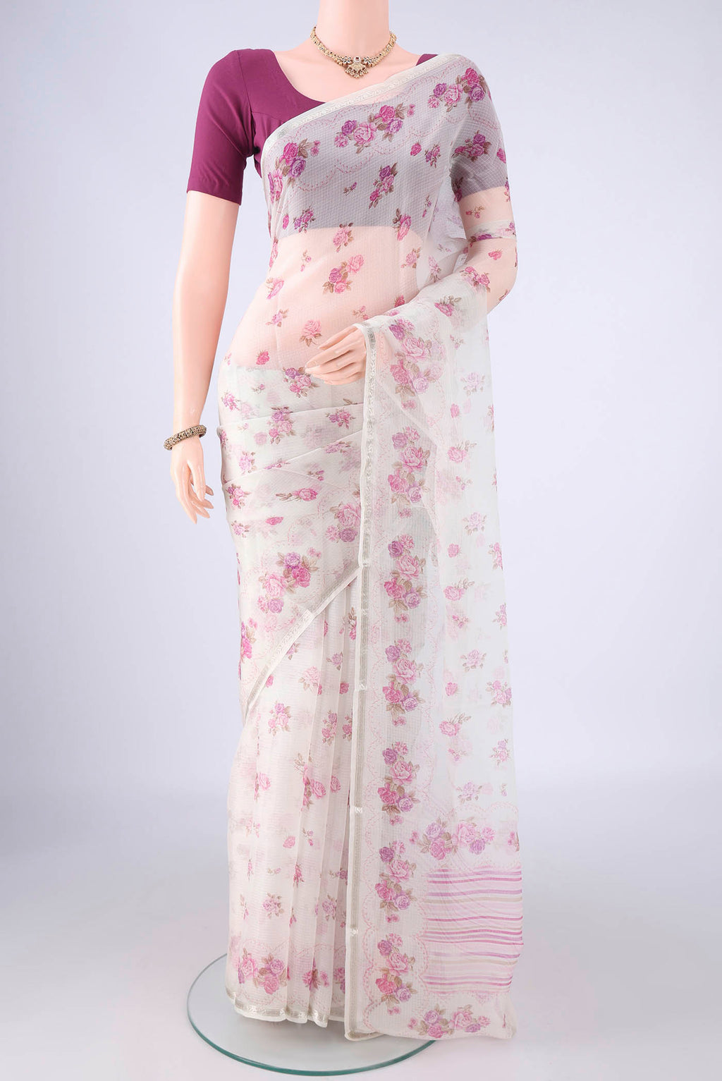 Pearl White Kota Silk Saree with Floral Print on the body and Zari Border.  displayed on a mannequin