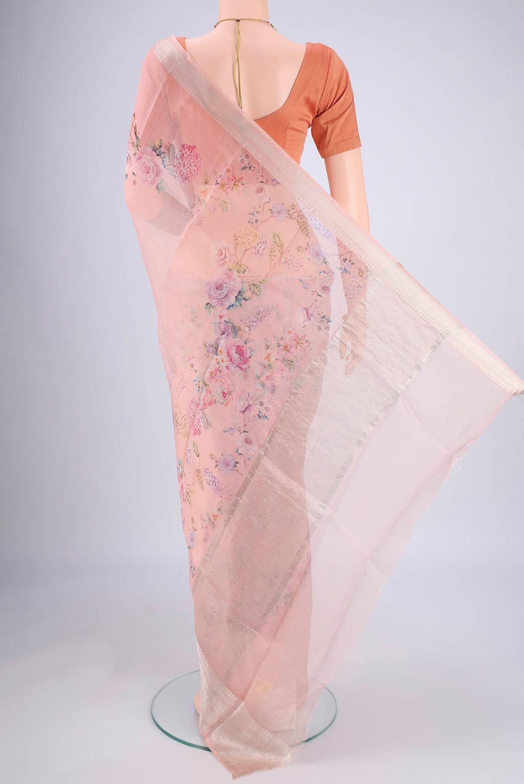 Flat view of Peach Kota Silk Saree with Floral Print on the body and Zari Border. 