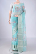 Sky Blue Kota Silk Saree with Floral Print on the body and Zari Border.  displayed on a mannequin