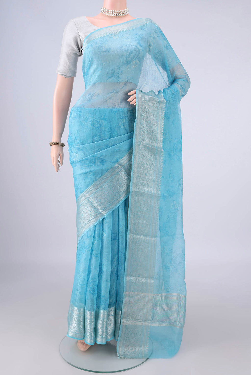 Pure Silk Sky Blue Kota Saree with Floral Print on the body and Zari Border.  displayed on a mannequin