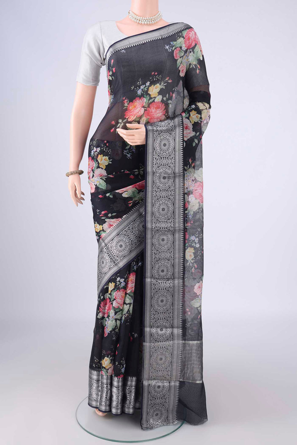 Black Kota Silk Saree with Floral Print on the body and Zari Border.  displayed on a mannequin