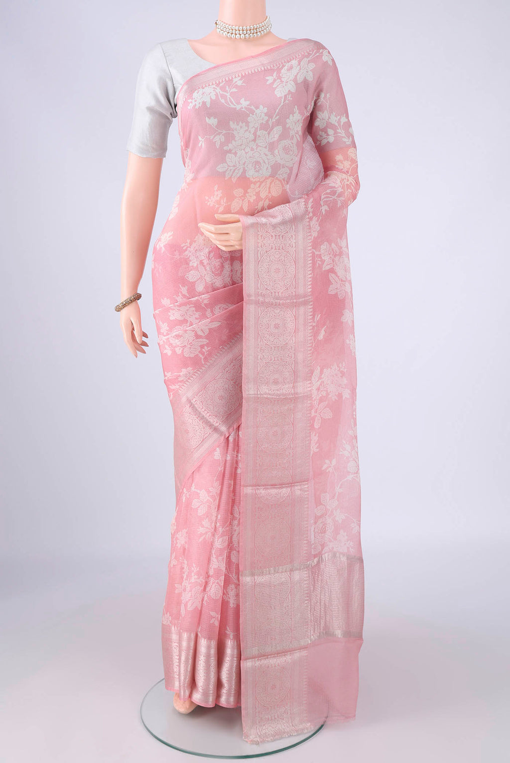 Pink Kota Silk Saree with Floral Print on the body and Zari Border.  displayed on a mannequin