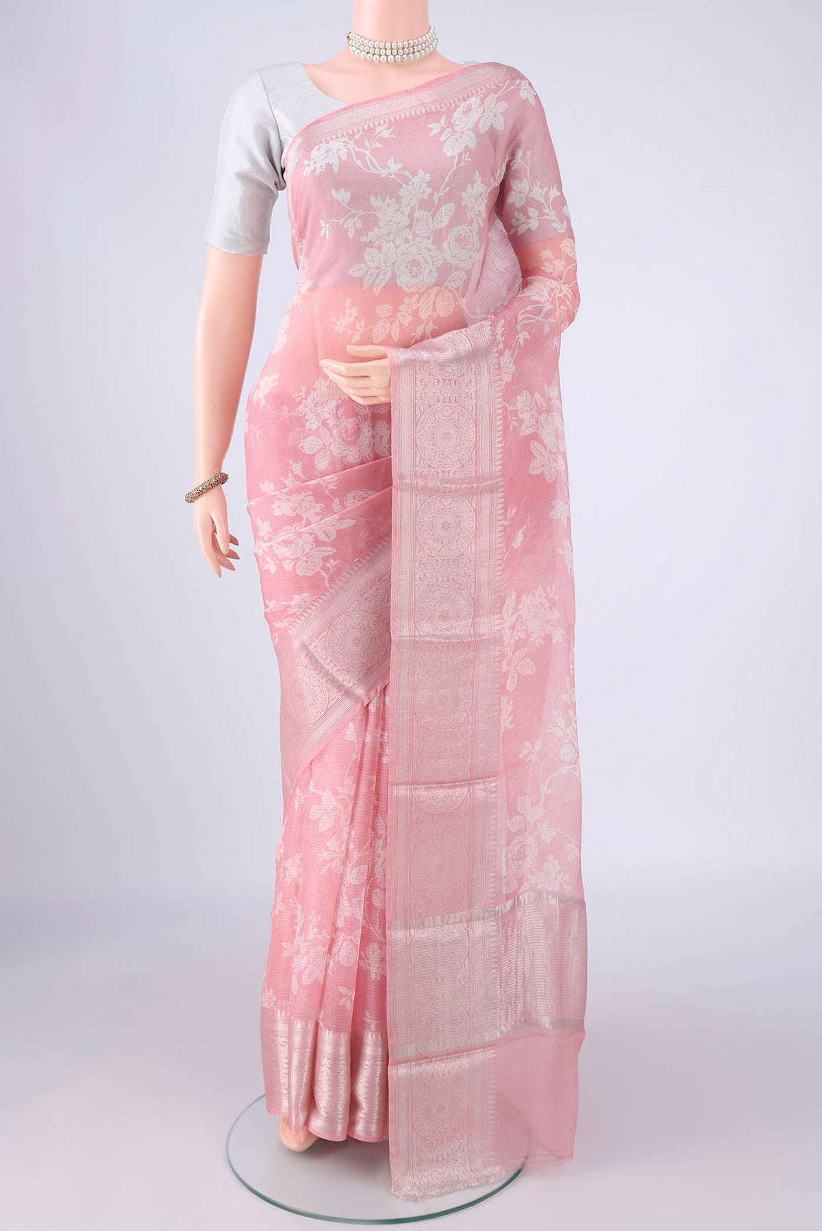 Pink Kota Silk Saree with Floral Print on the body and Zari Border.  displayed on a mannequin