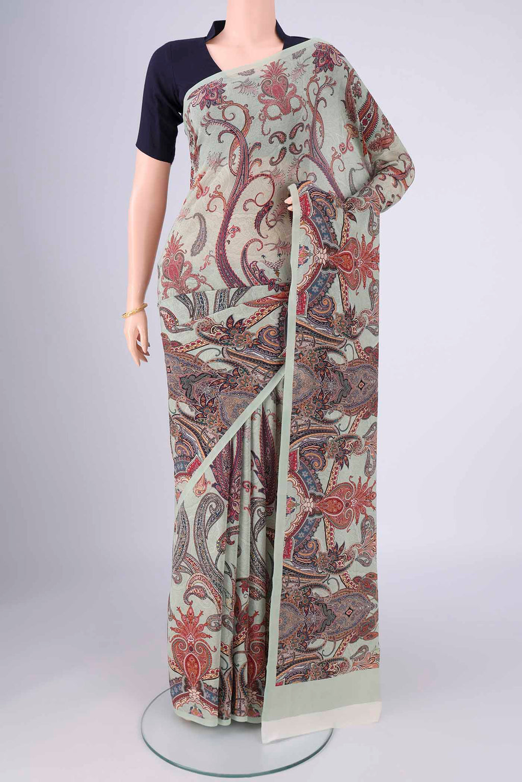 Sage Green Mysore Crepe Saree with Printed design on the body and Printed Border.  displayed on a mannequin