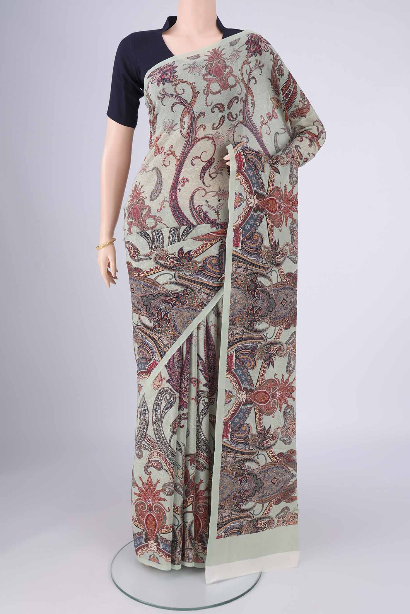 Sage Green Mysore Crepe Saree with Printed design on the body and Printed Border.  displayed on a mannequin