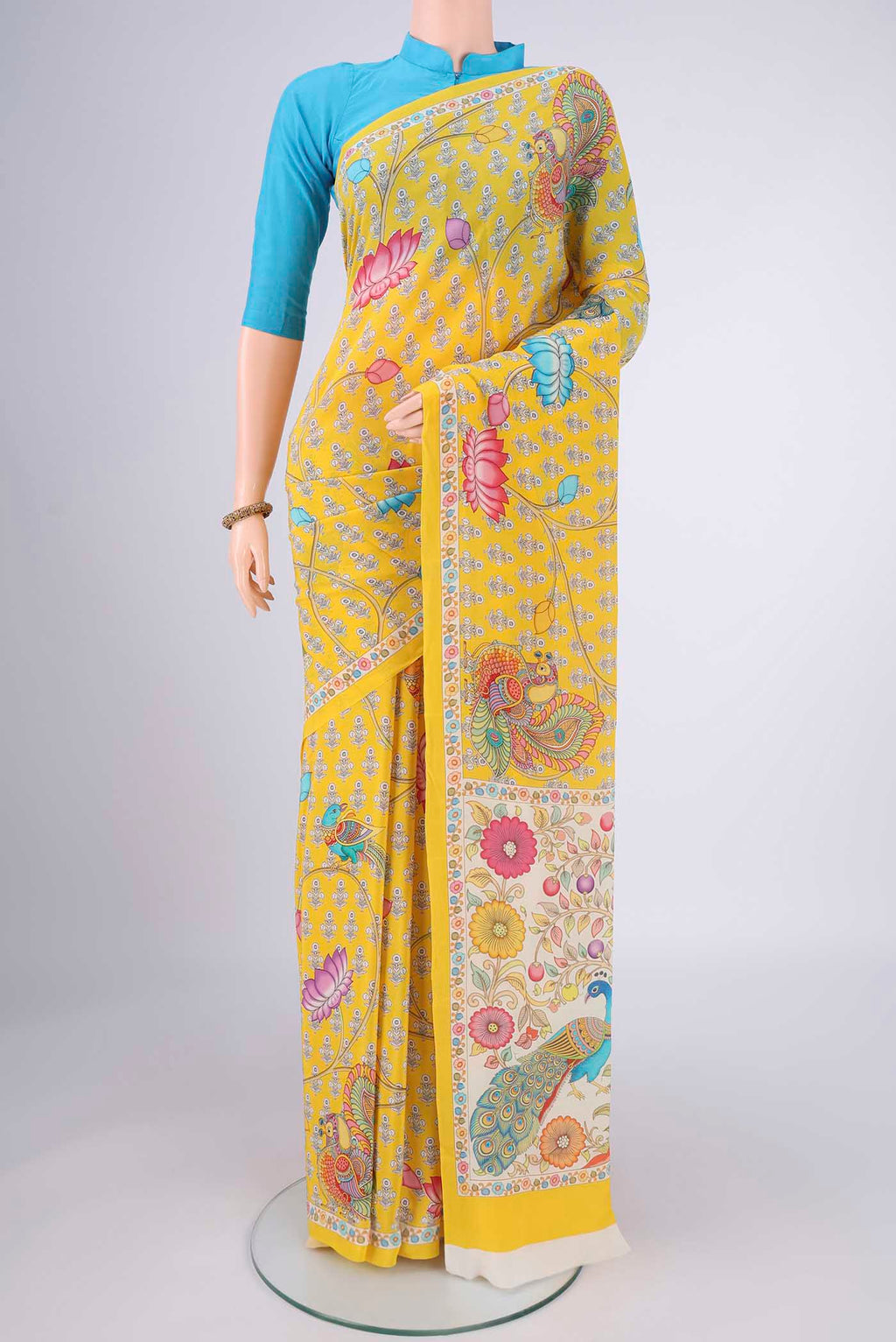 Yellow Mysore Crepe Saree with Printed design on the body and Printed Border.  displayed on a mannequin