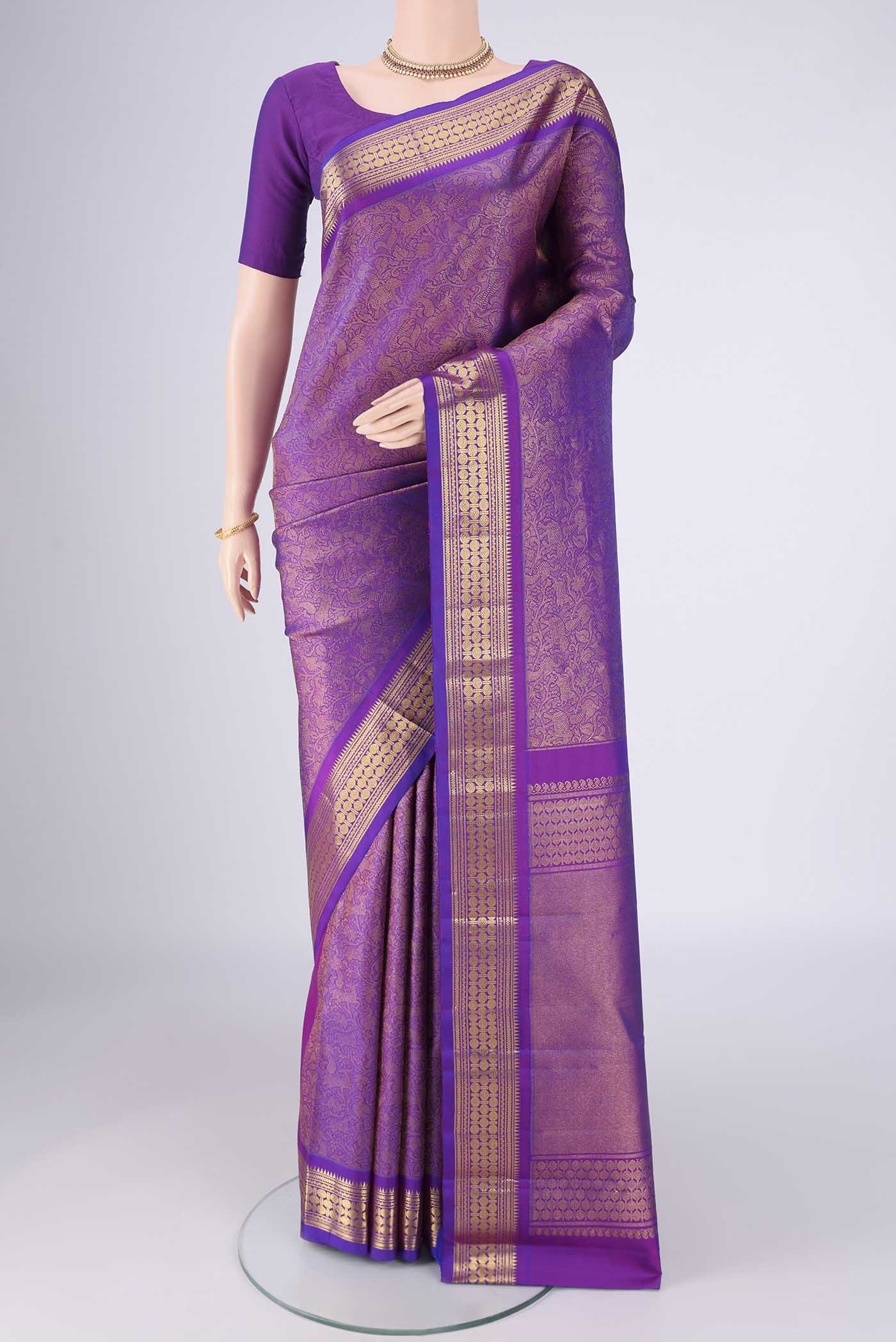 Purple Kanjivaram Silk Saree with Zari Brocade on the body and Zari Border.  displayed on a mannequin