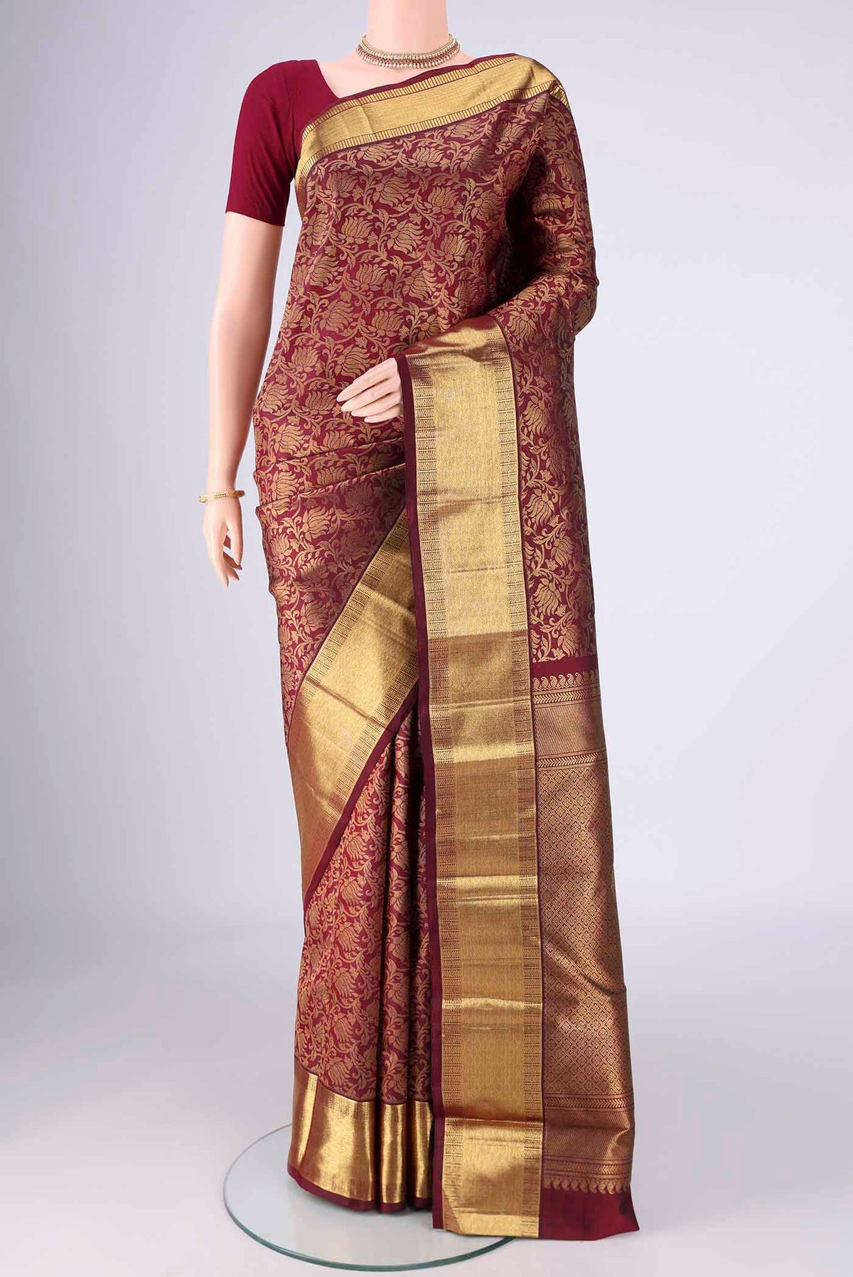 Pure Silk Pure Zari Maroon Kanjivaram Saree with Zari Brocade on the body and Zari Border.  displayed on a mannequin