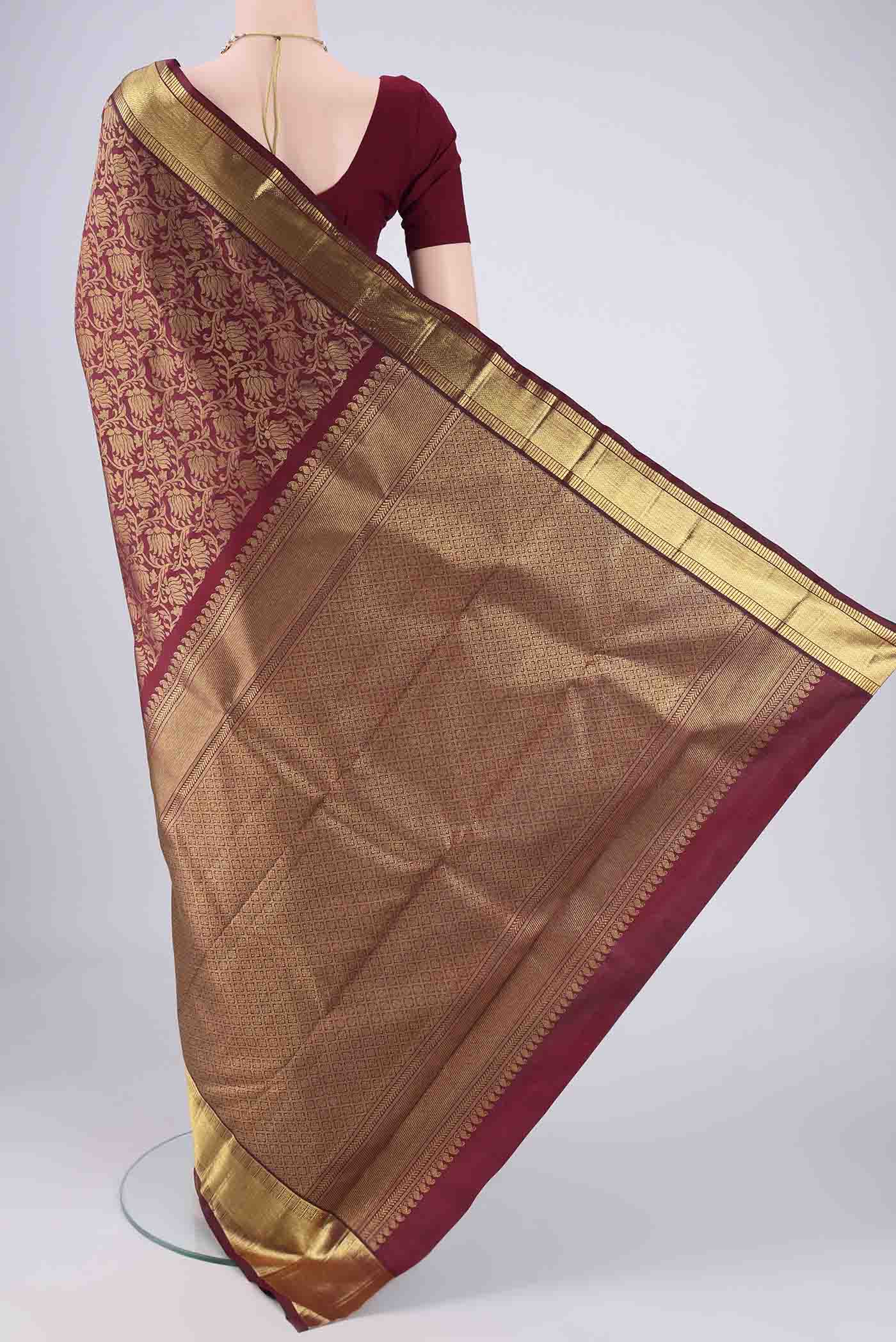 Flat view of Pure Silk Pure Zari Maroon Kanjivaram Saree with Zari Brocade on the body and Zari Border. 