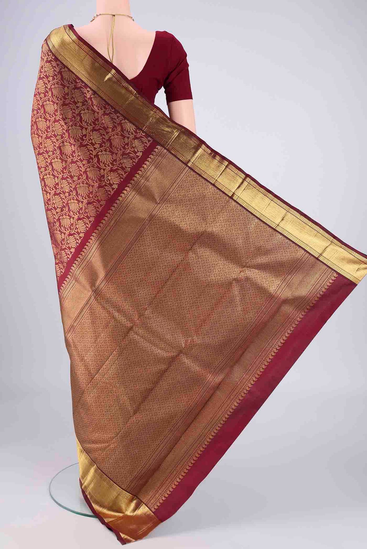 Flat view of Pure Silk Pure Zari Maroon Kanjivaram Saree with Zari Brocade on the body and Zari Border. 