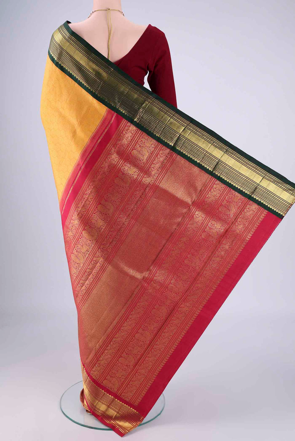 Flat view of Pure Silk Pure Zari Yellow Kanjivaram Saree with Zari Brocade on the body and Ganga Jamuna Border. 