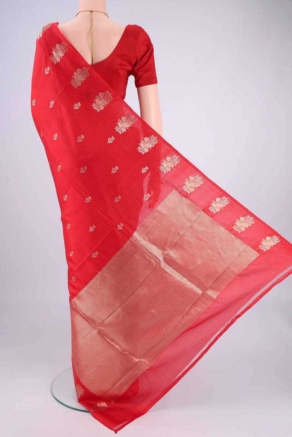 Flat view of Red Banarasi Katan Silk Saree with Zari Butta on the body and Plain Border. 