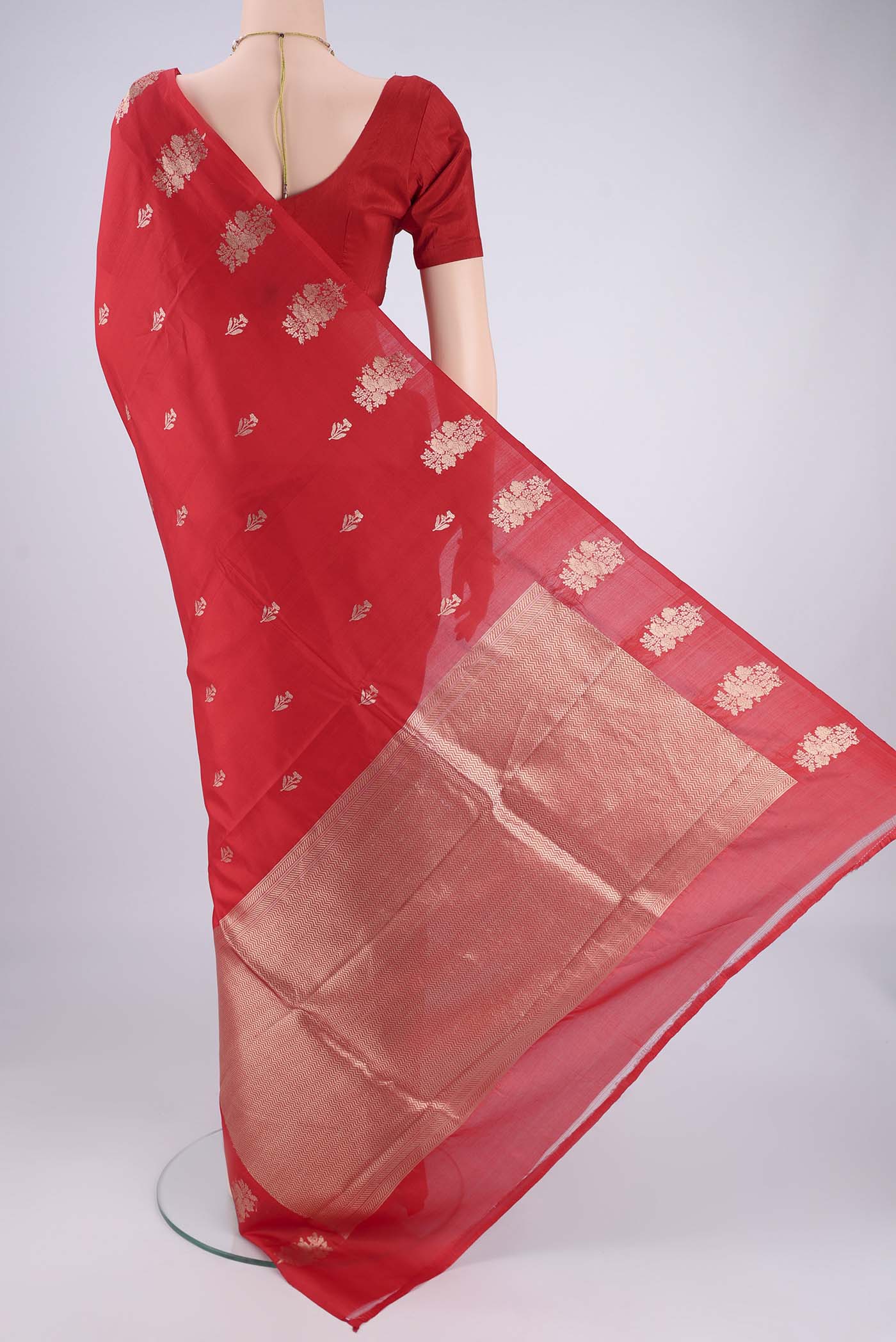 Flat view of Red Banarasi Katan Silk Saree with Zari Butta on the body and Plain Border. 