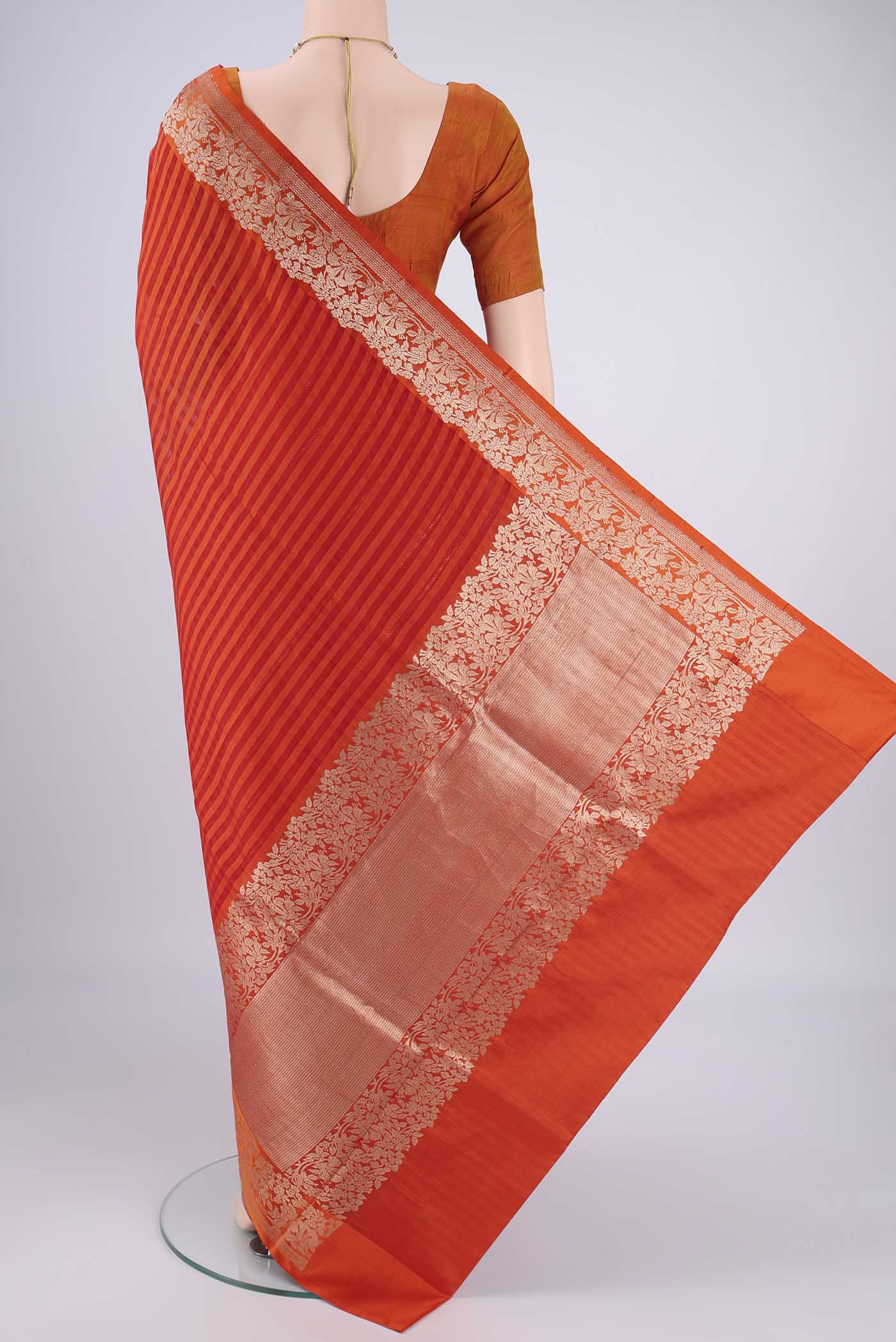 Flat view of Orange Organza Silk Saree with Stripes on the body and Silk Border. 