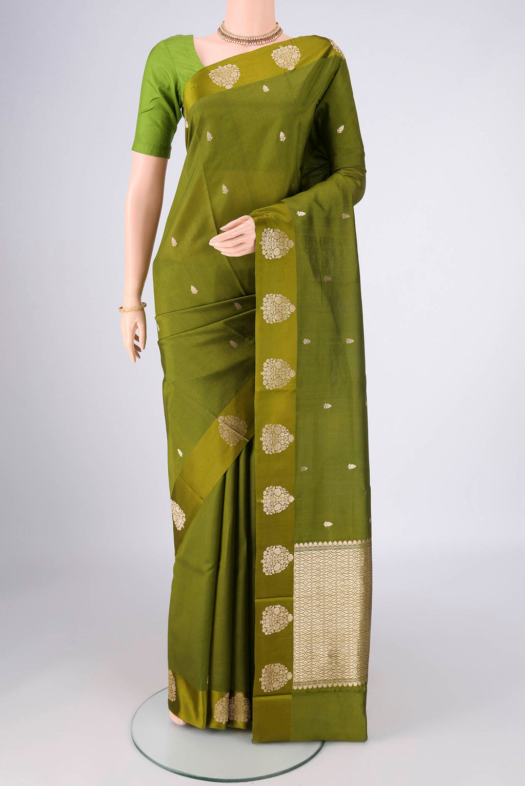 Mehandi Green Banarasi Katan Silk Saree with Zari Butta on the body and Plain Border.  displayed on a mannequin
