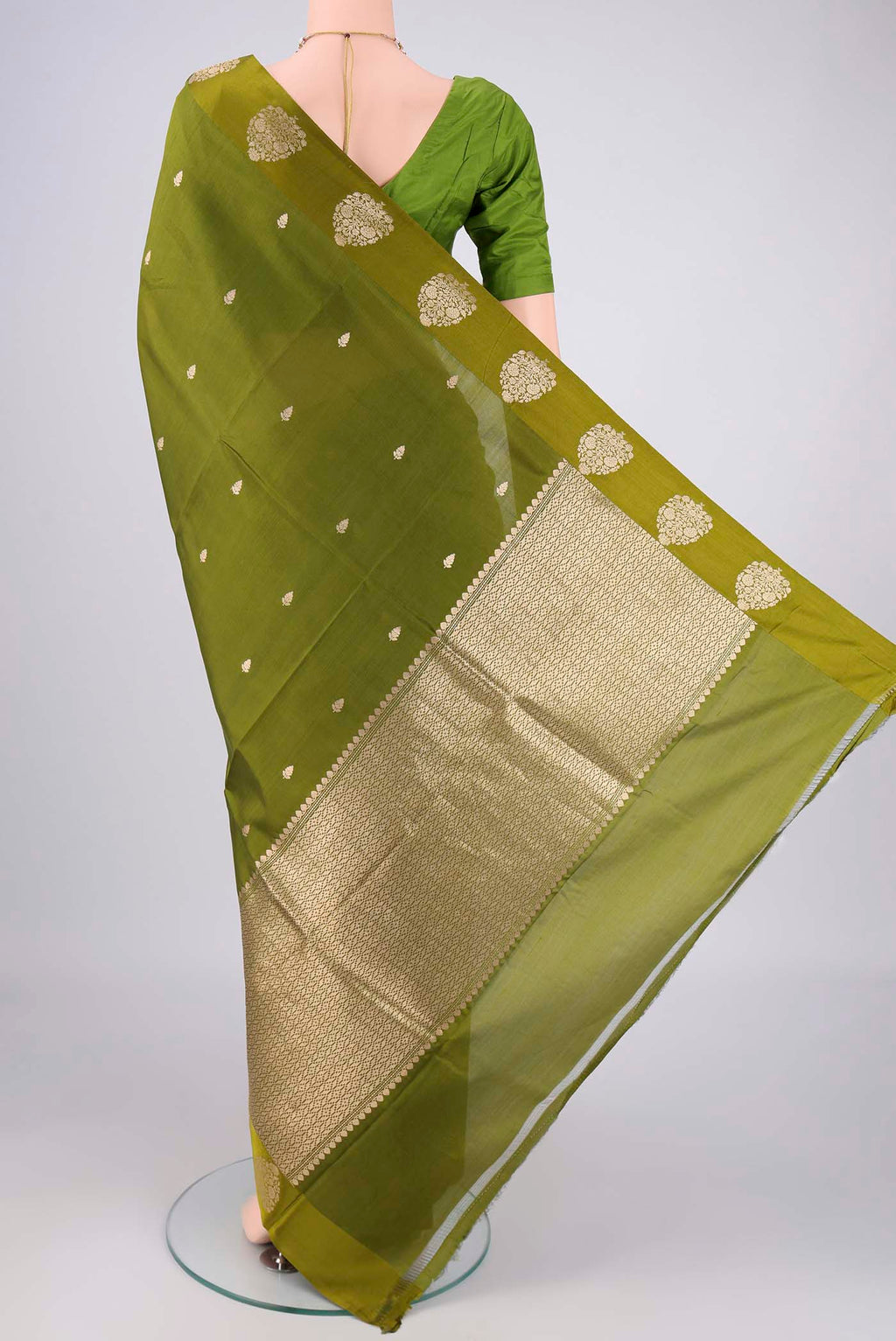 Flat view of Mehandi Green Banarasi Katan Silk Saree with Zari Butta on the body and Plain Border. 