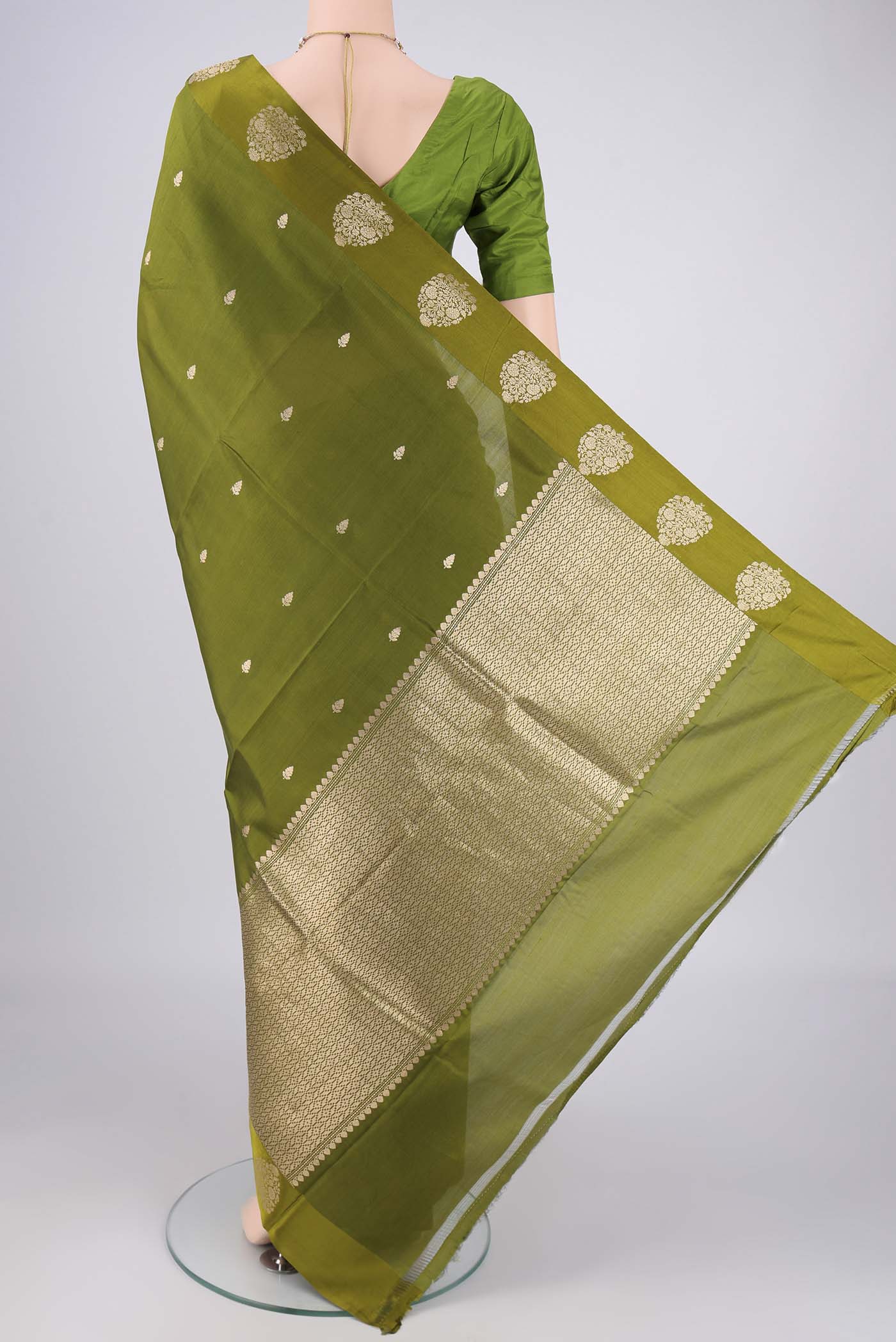 Flat view of Mehandi Green Banarasi Katan Silk Saree with Zari Butta on the body and Plain Border. 