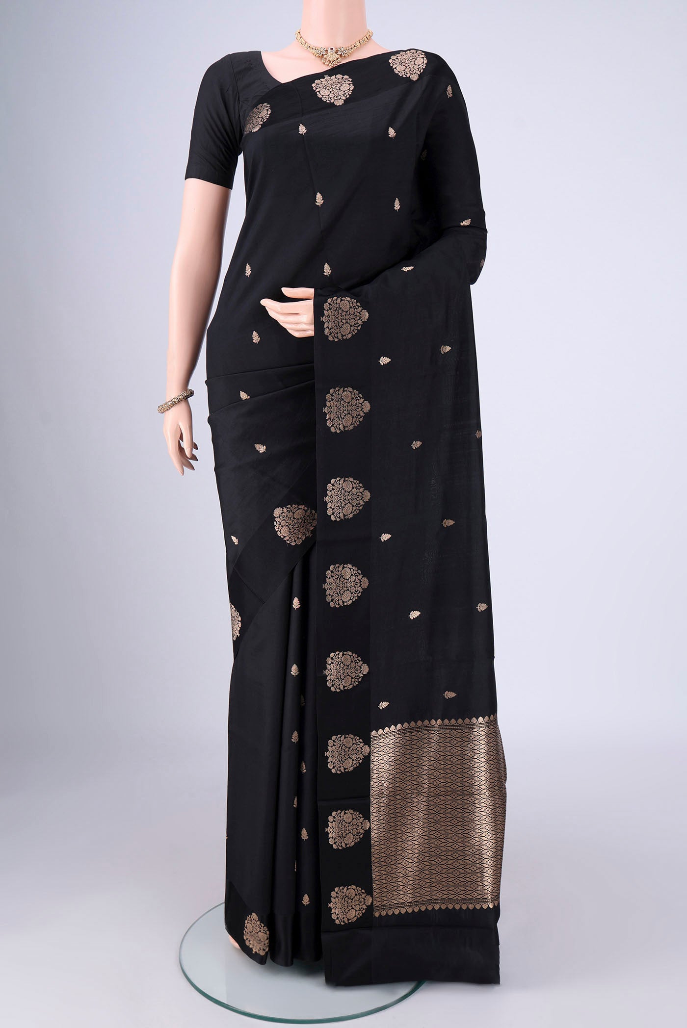 Black Banarasi Katan Silk Saree with Zari Butta on the body and Satin Border.  displayed on a mannequin