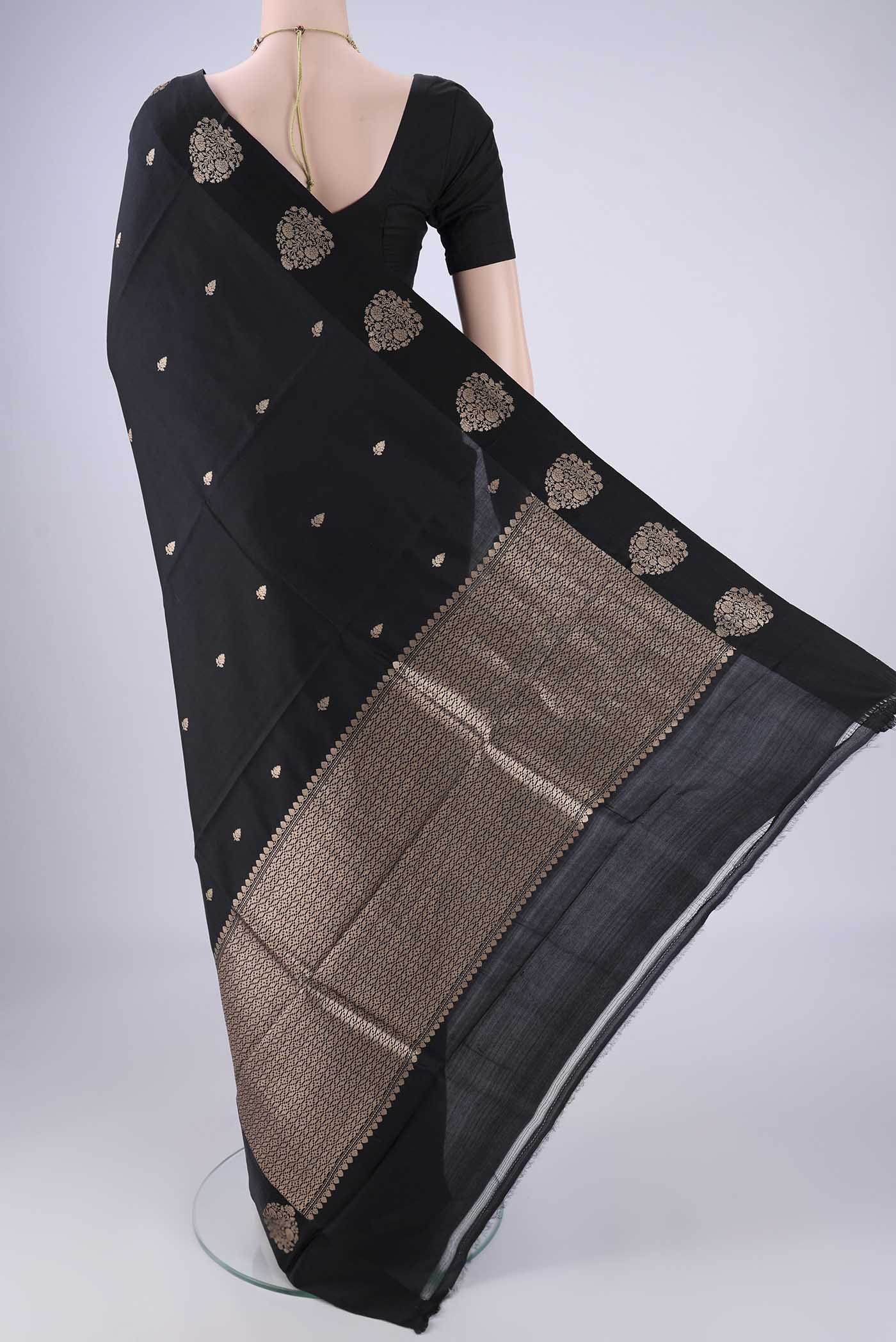 Flat view of Black Banarasi Katan Silk Saree with Zari Butta on the body and Satin Border. 