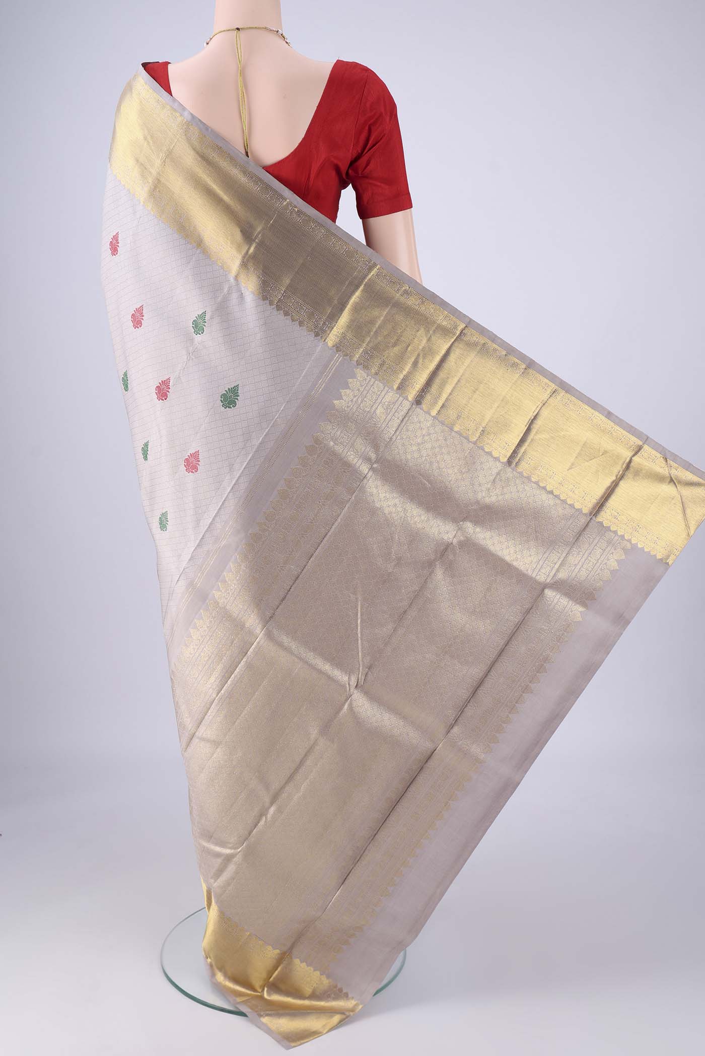 Flat view of Grey Kanjivaram Silk Saree with Jacquard With Thread Butta on the body and Zari Border. 