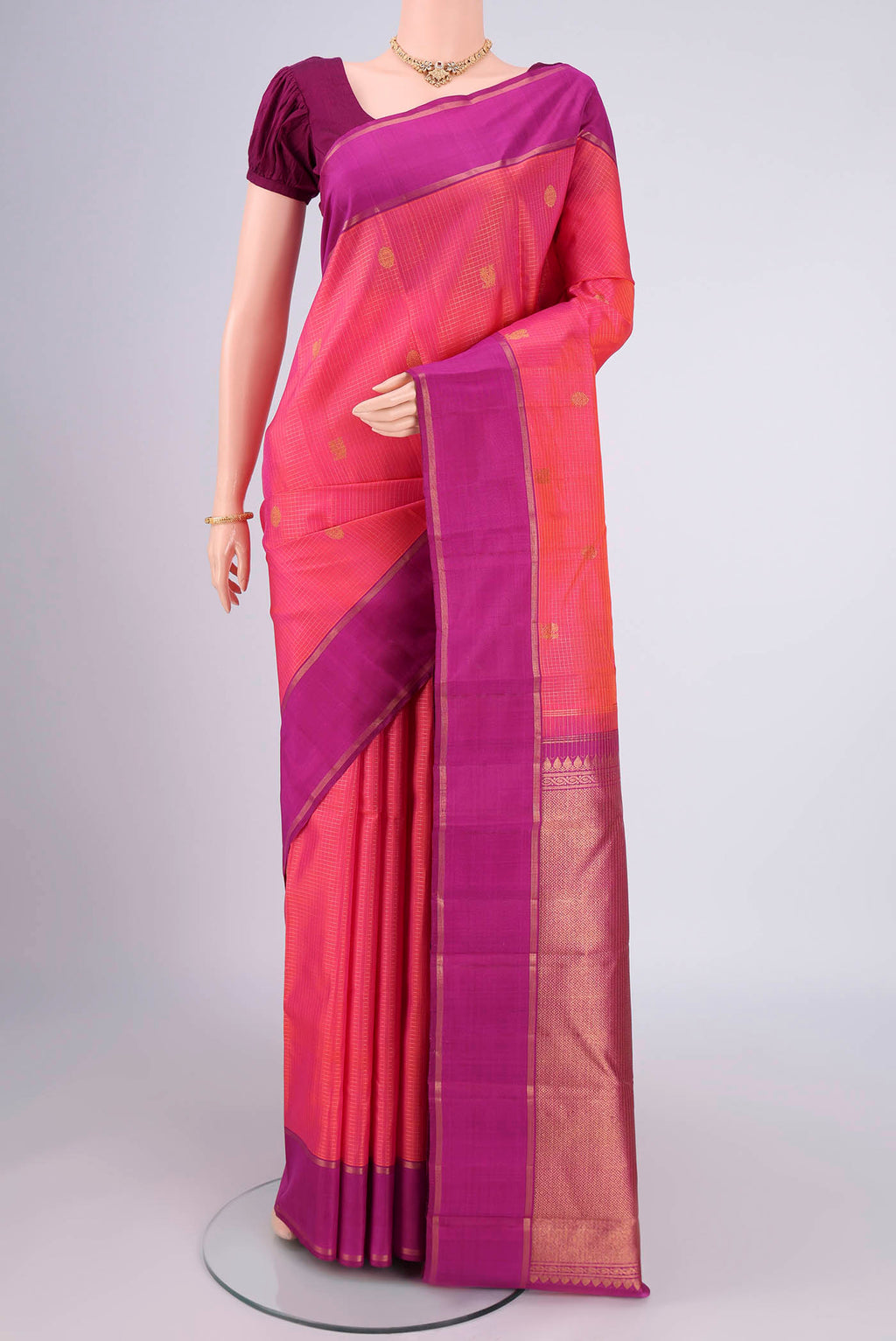 Pink with Orange Color Kanjivaram Silk Saree with Checked design on the body and Zari Border.  displayed on a mannequin