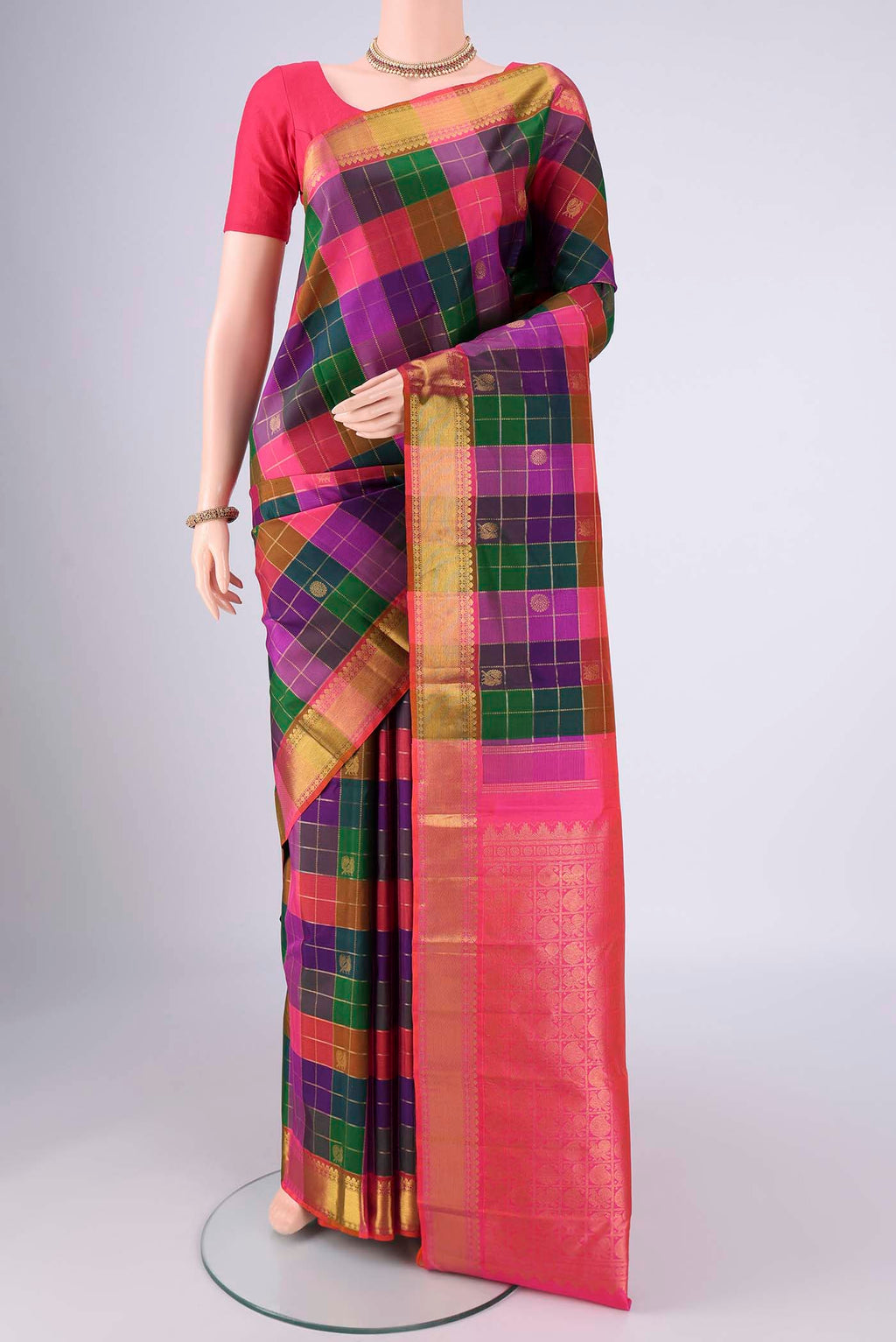 Multi Color Kanjivaram Silk Saree with Checked design on the body and Zari Border.  displayed on a mannequin