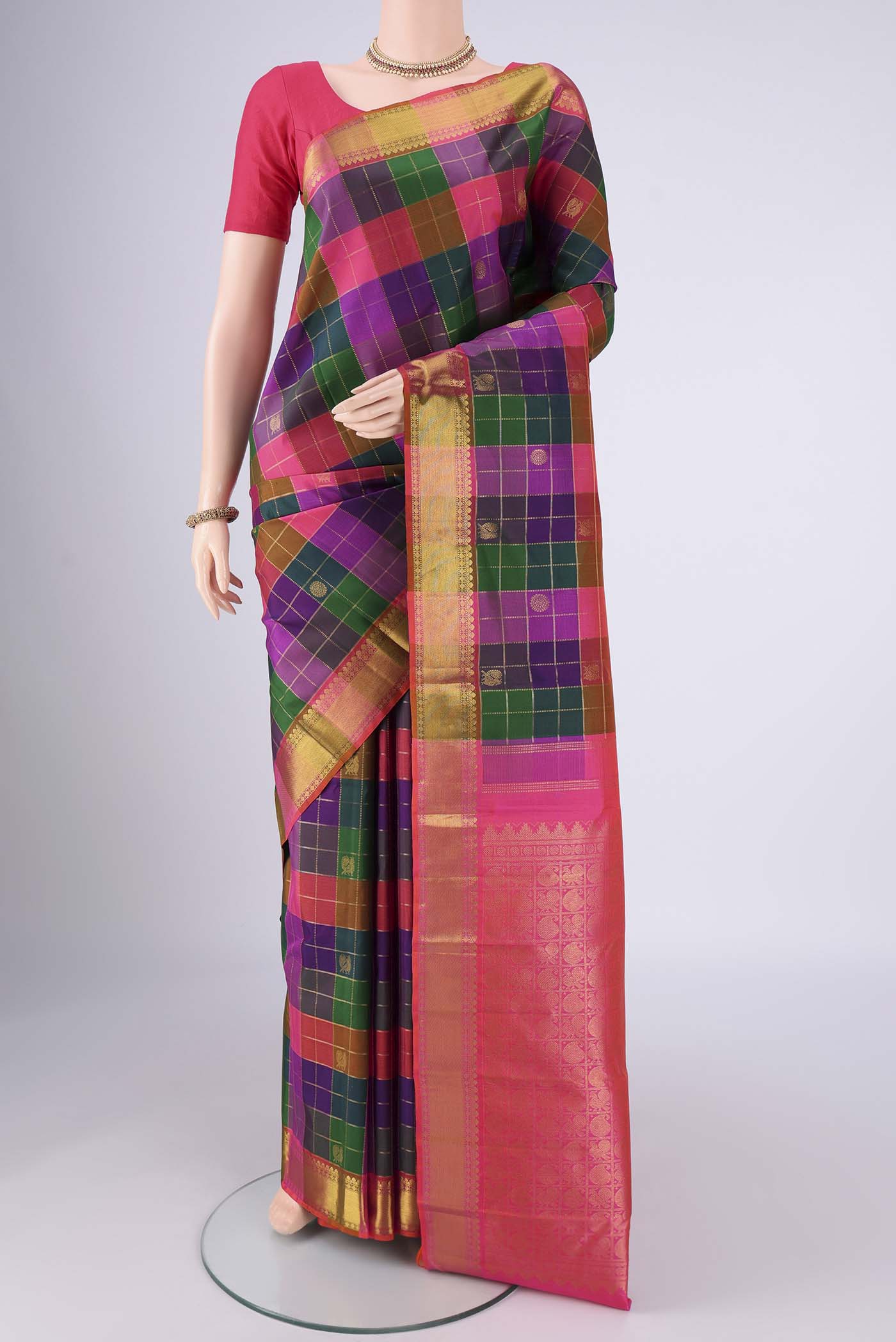 Multi Color Kanjivaram Silk Saree with Checked design on the body and Zari Border.  displayed on a mannequin