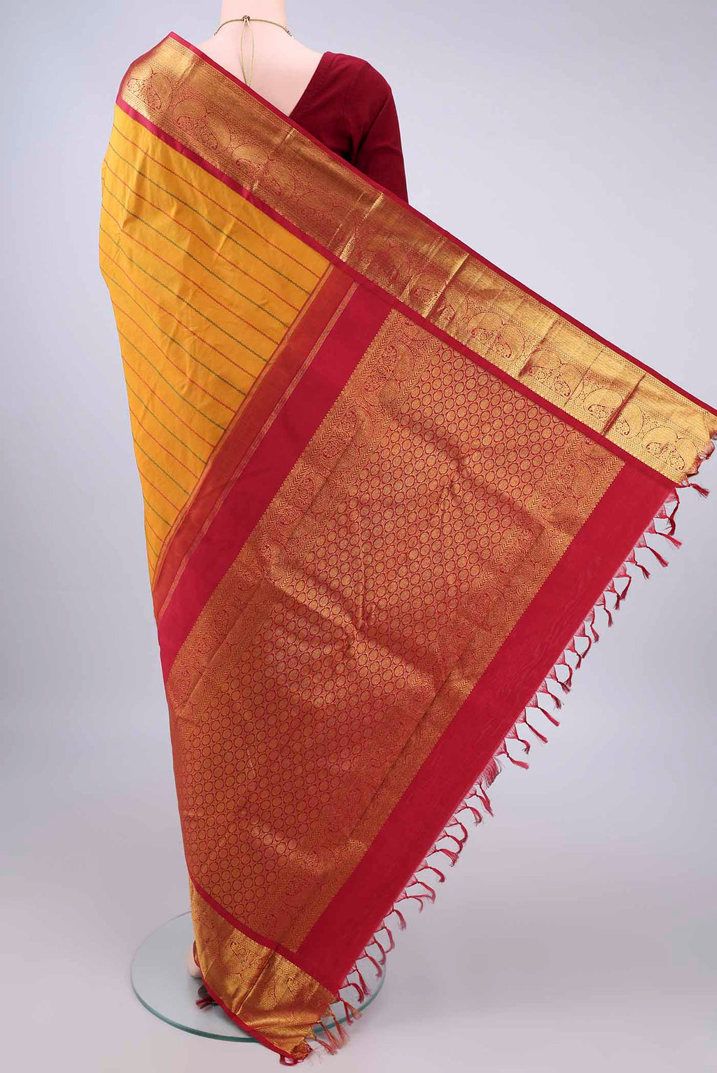 Flat view of Pure Silk Mustard Kanjivaram Saree with Veldhari on the body and Zari Border. 