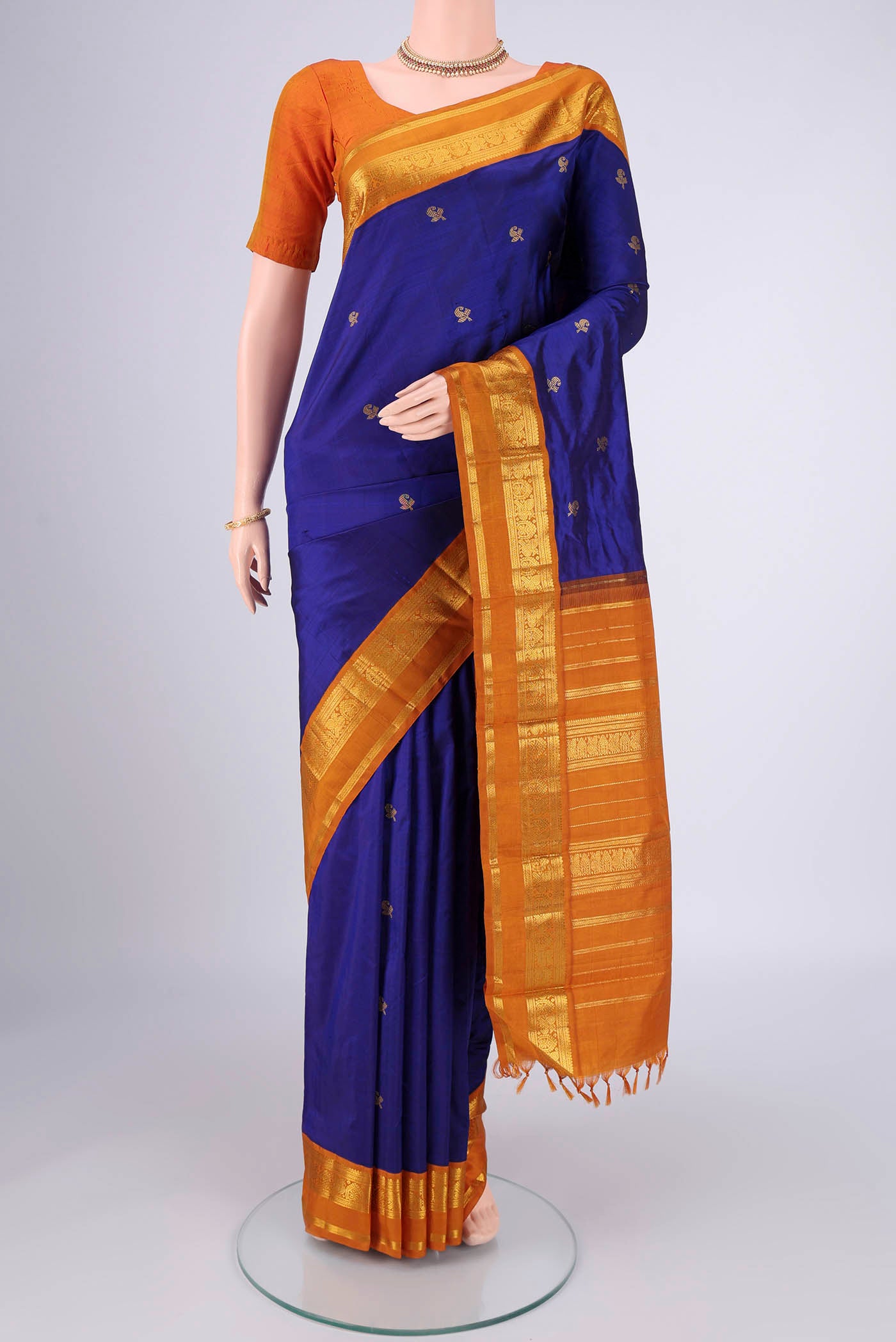 Blue Kanjivaram Silk Saree with Zari Butta on the body and Zari Border.  displayed on a mannequin