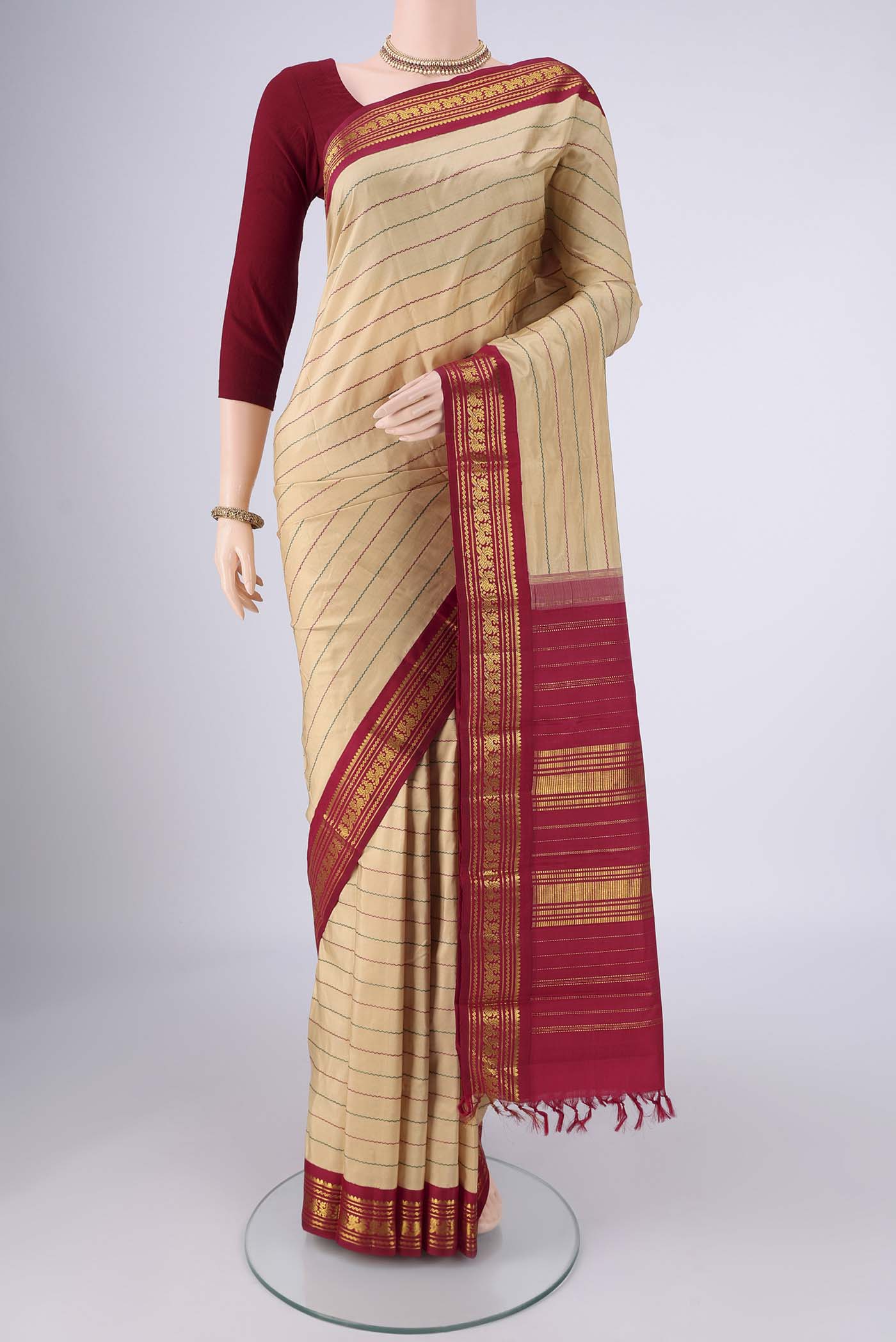 Beige Kanchipuram Silk Saree with Veldhari on the body and Zari Border.  displayed on a mannequin